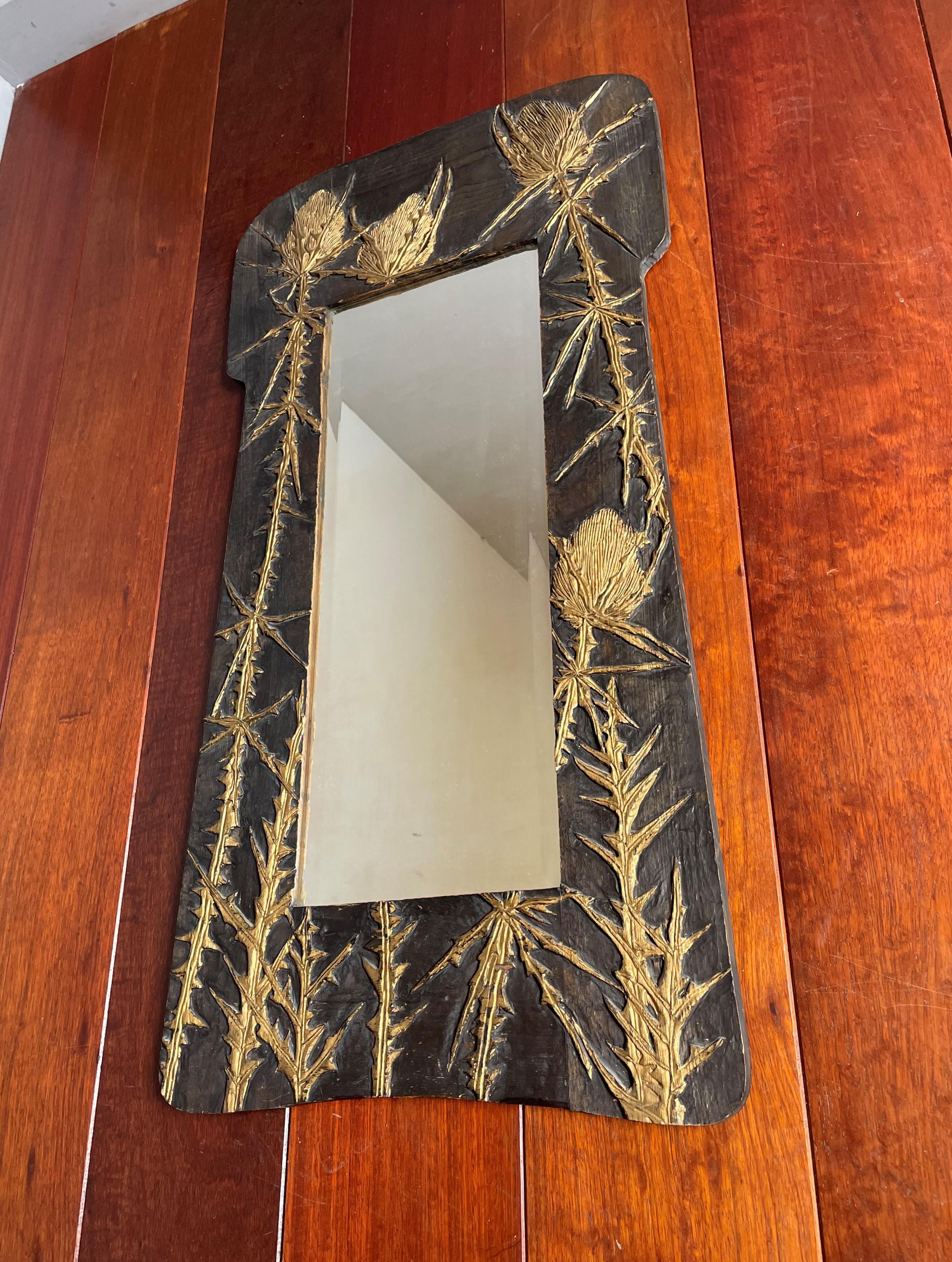 Striking wall mirror with handcarved 'blue thistles'.

Via one of our foreign contacts we recently purchased this perfectly realistic thistle sculptures wall mirror. This all handcarved wooden frame displays a group of blue thistles (as they are