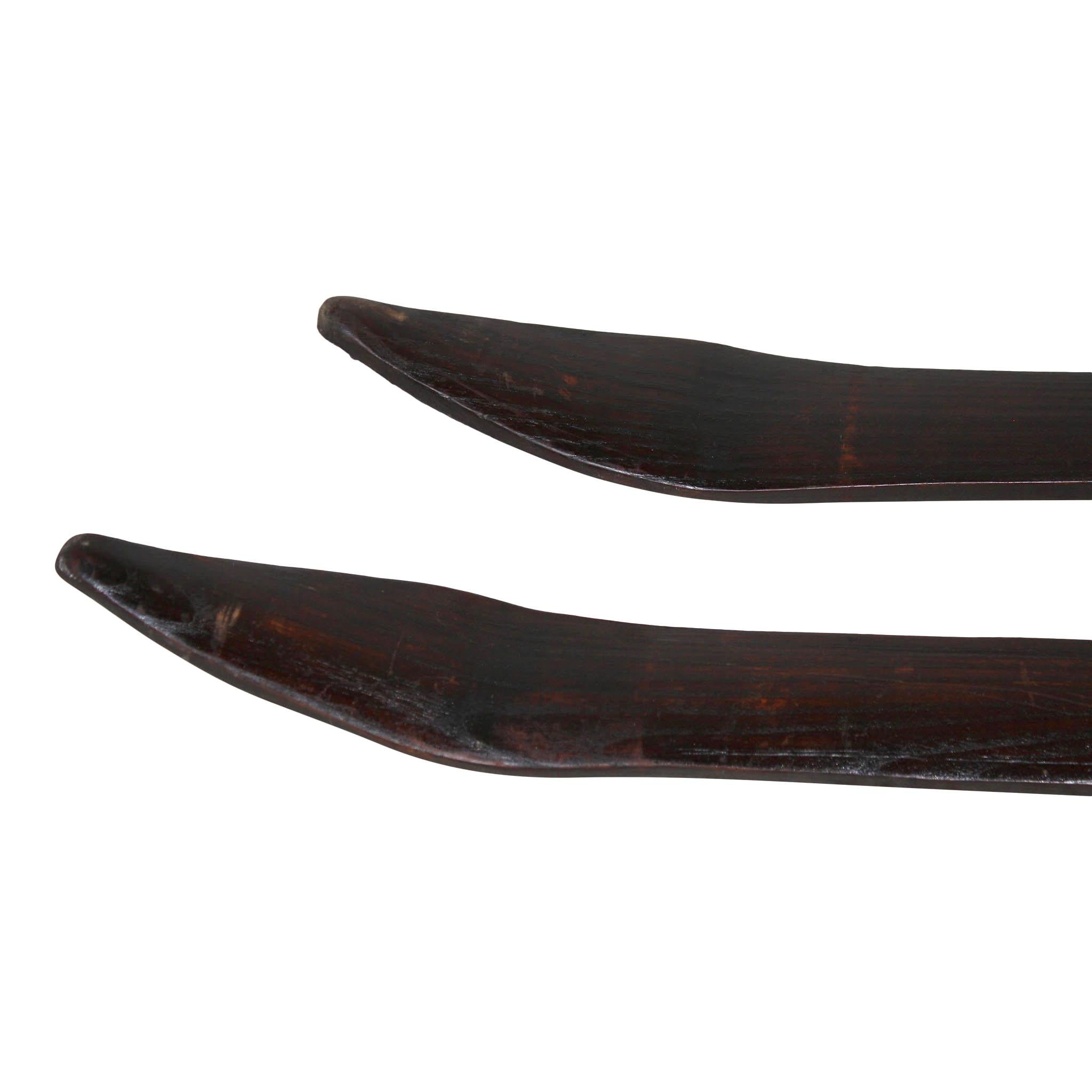 Hand carved from Scandinavia, this rare, long pair of ash skis is equipped with early leather bindings.