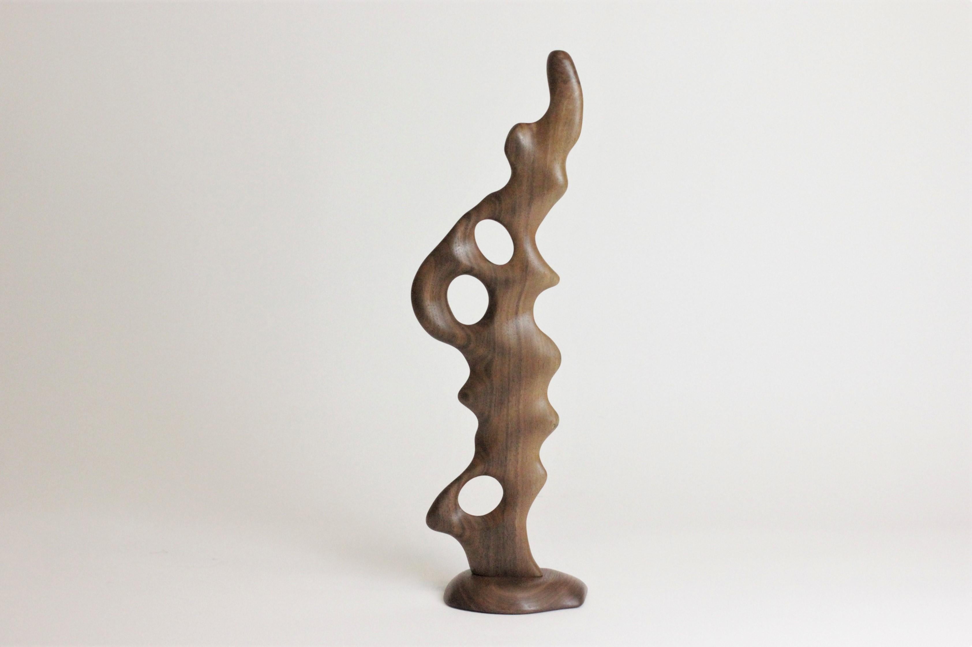 One-of-a-kind sculpture inspired by biomorphic shapes. hand carved by an independent wood-turning British artist from a single, solid piece of wood coated with wax layers to emphasise the natural grain pattern and sanded and buffed to a smooth