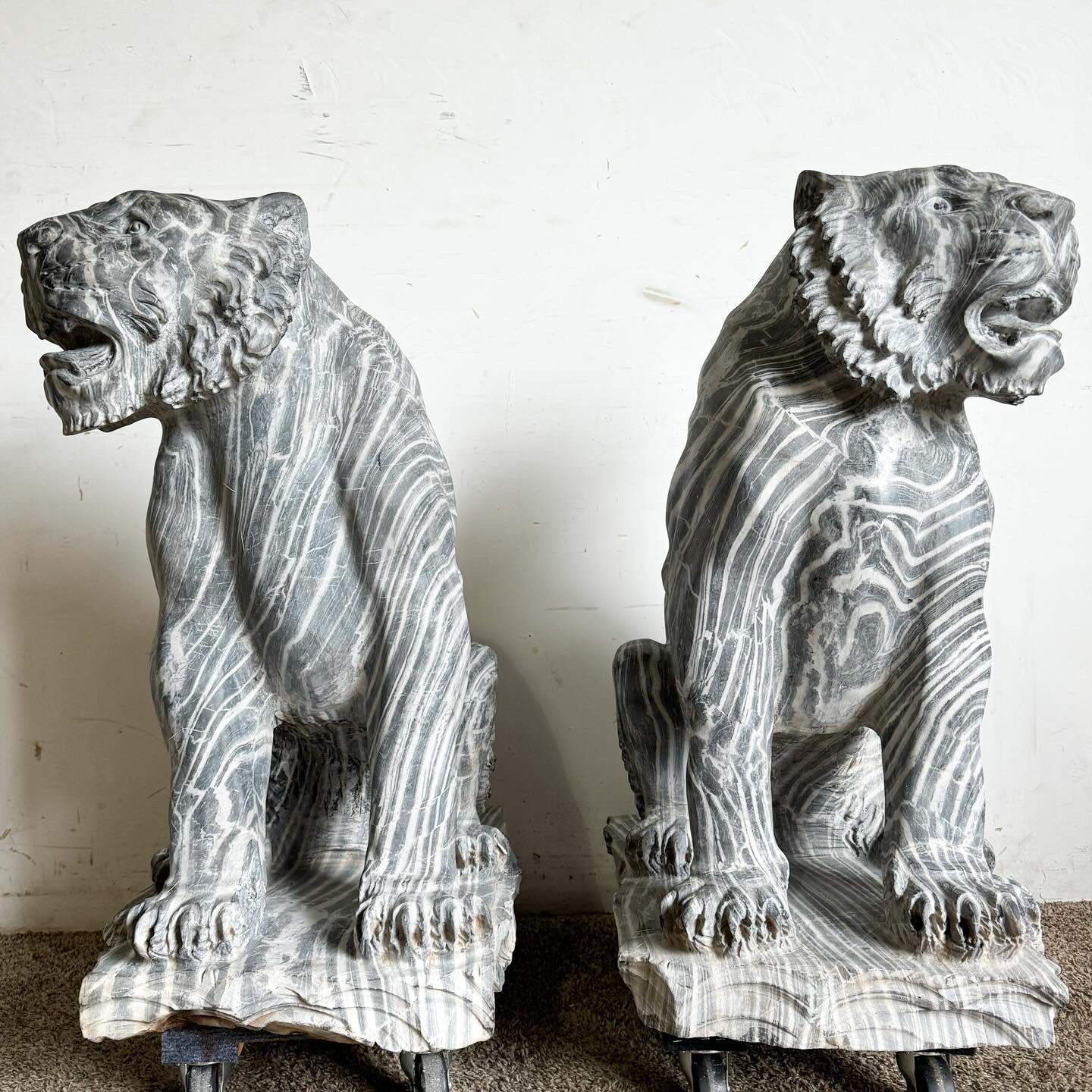 Behold the majesty and artistry of these Hand Carved Black Marble Tiger Statues, a truly exceptional pair. Each statue is masterfully crafted from solid black marble, resulting in a weighty and substantial feel. The level of detail in the carving is