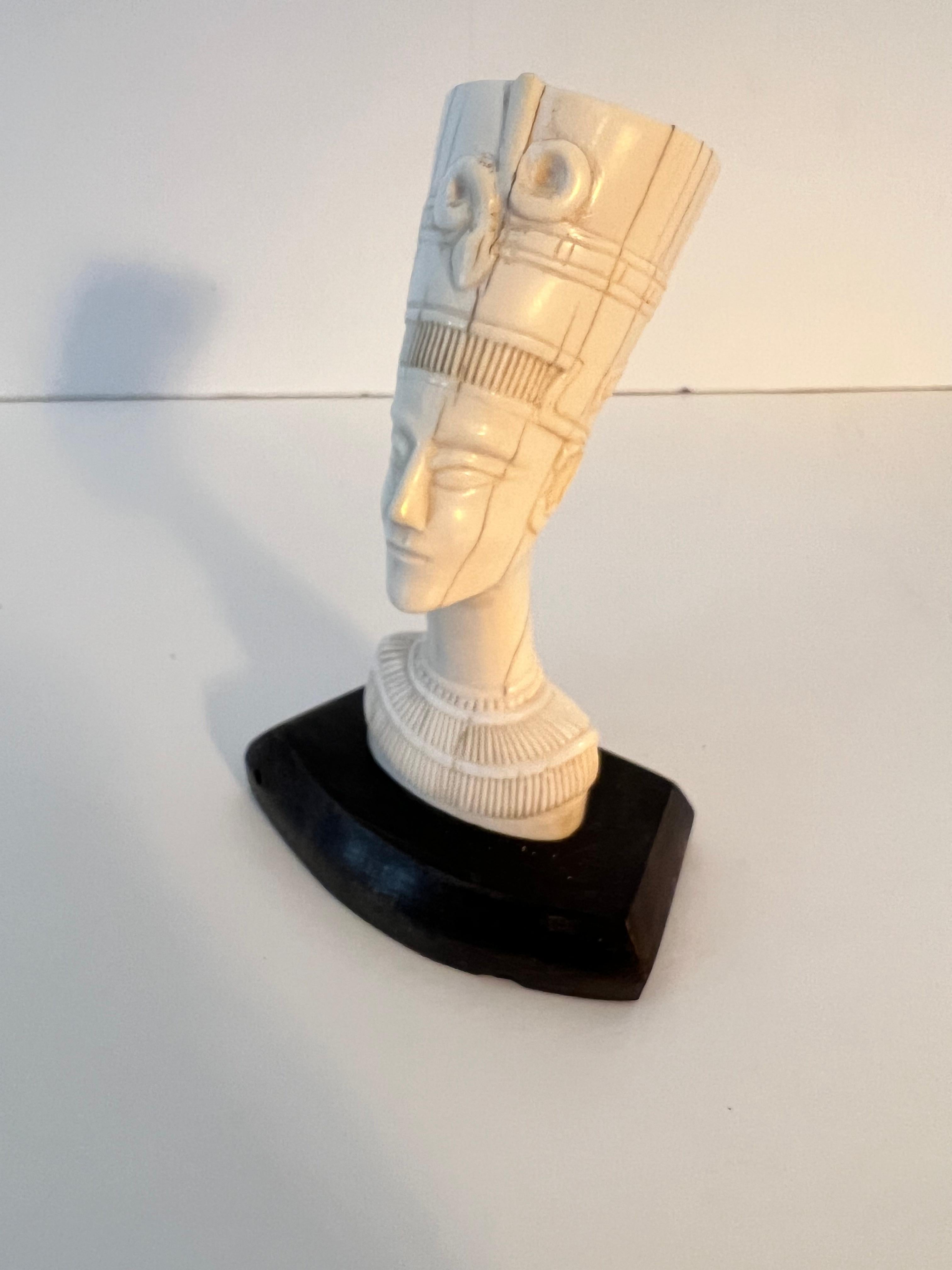 A Wonderful Carved Nefertiti Head on Base. The piece is carved bone and finely detailed.

A compliment to many spaces - on a shelf, or as a paper weight on a desk or work station. A truly spectacular piece.