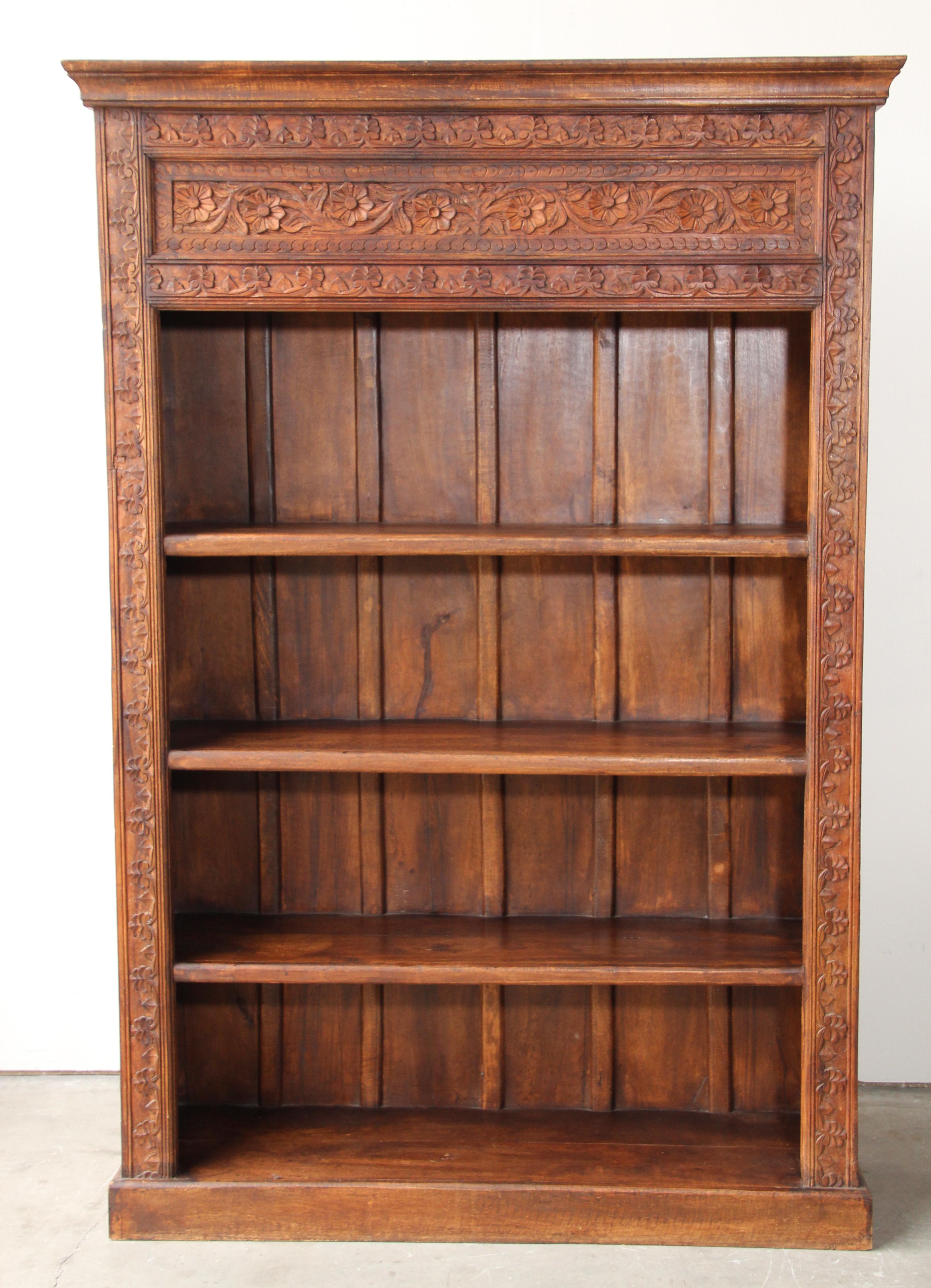 Solid teak wood with superb 19th century carvings on the wood columns and on the frames. It is so well made and it will last several decades handcrafted in India,
hand carved teak wood book shelf.