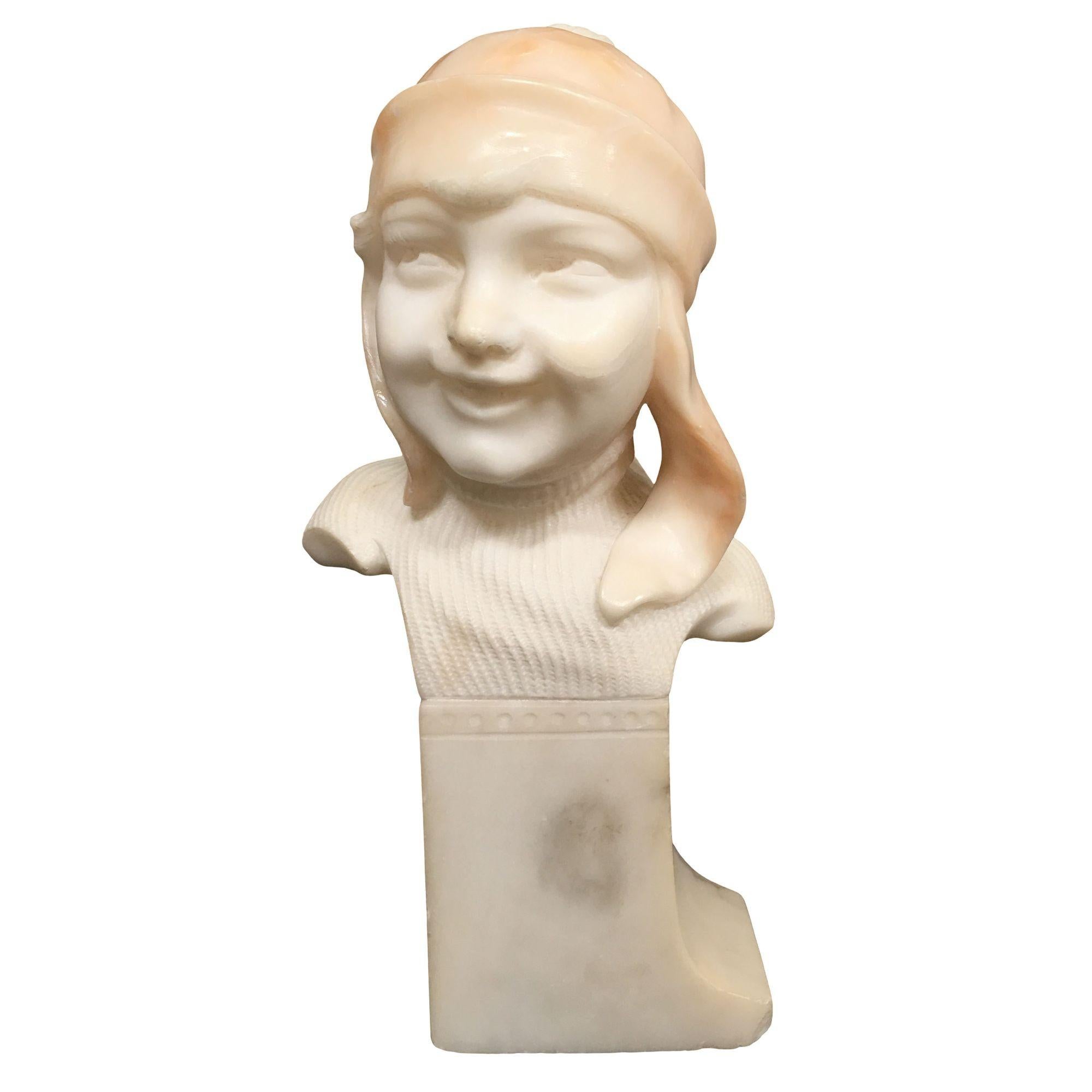 Modern hand carved Alabaster bust set featuring a bother and sister in snow gear. The girl is smiling with a bob haircut and the boy has a toboggan cap on.
