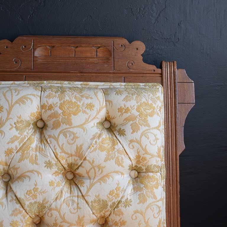 Chaise en bois sculptée à la main dans le style d'Eastlake. La chaise est dotée d'un tissu brocart crème et jaune, d'un dossier capitonné touffeté et d'un siège assorti. La tapisserie est en excellent état, avec un double passepoil partout. Le