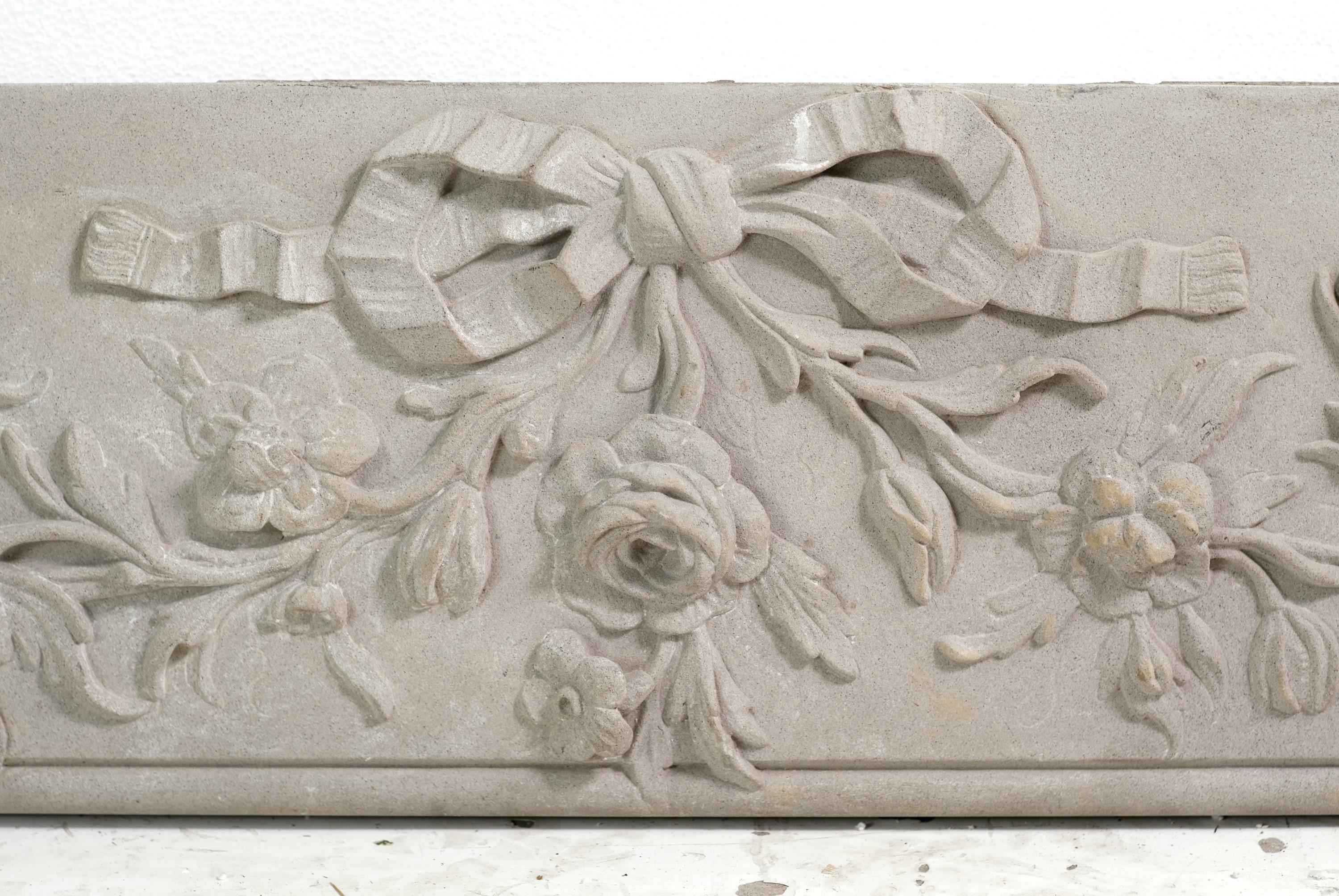 Early 20th century building façade piece. Hand carved from solid stone. Ornate details include ribbon swags, flowers, small creatures such as a dragonfly, caterpillar, and snails. Original building paint. Please note, this item is located in our