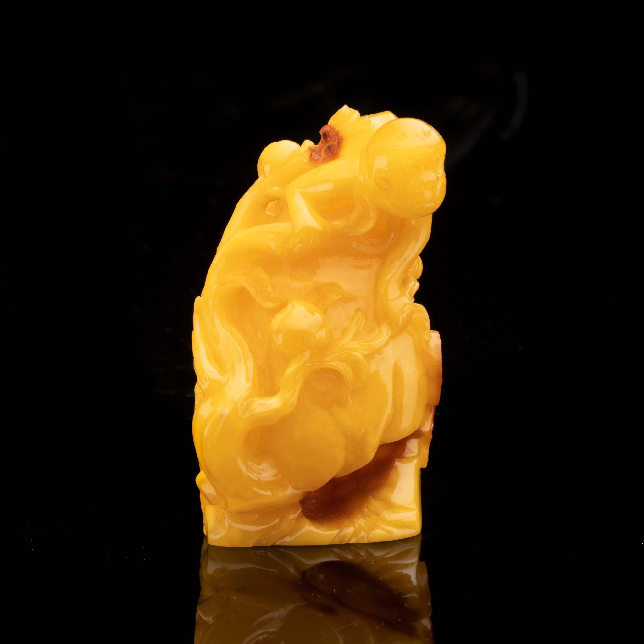 Contemporary Hand-Carved Butterscotch Amber Monkey on Rock // 57.13 Grams For Sale