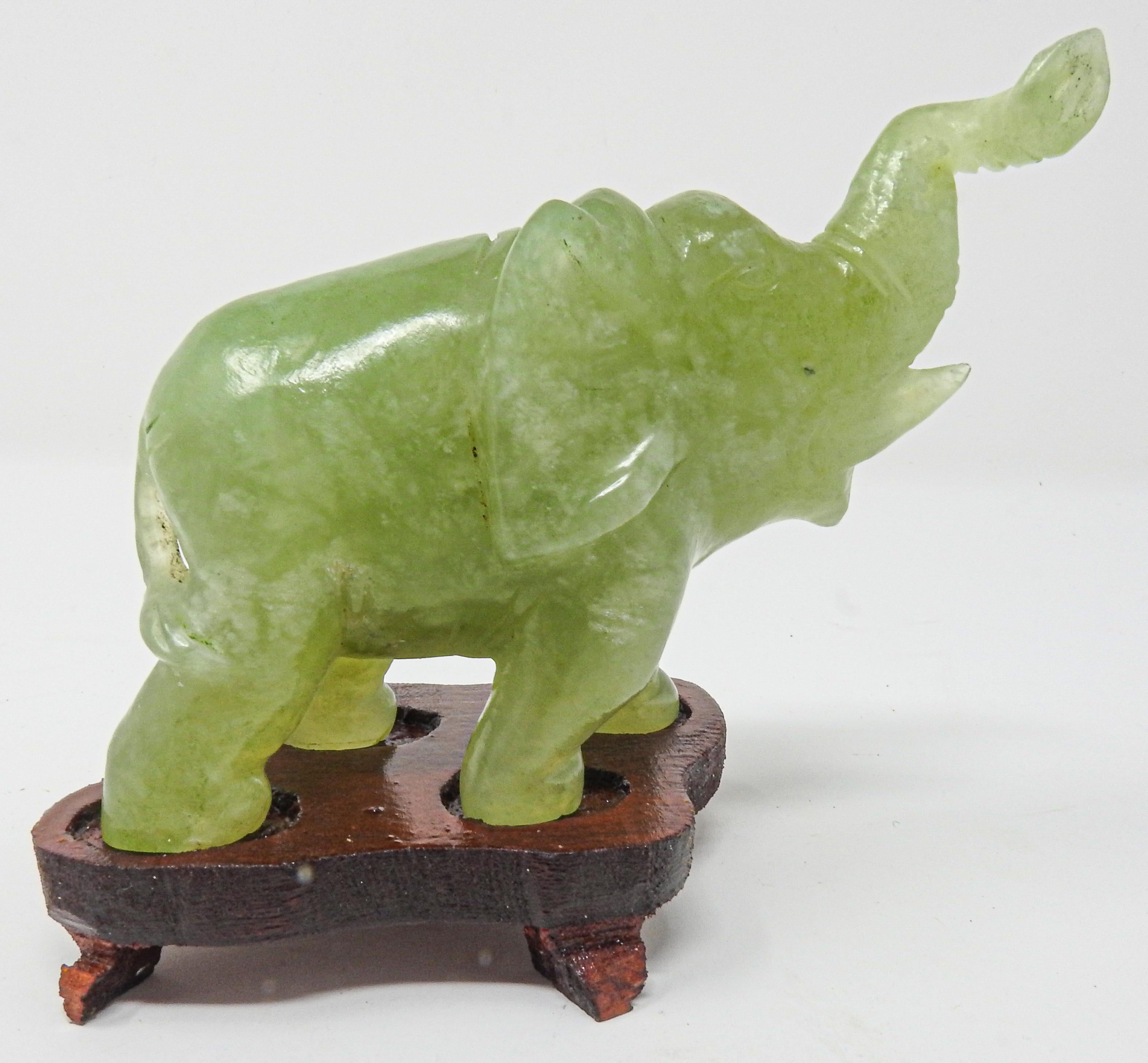 Offering this stunning hand carved Calcite elephant. The base is a simple hand carved base for the elephant to sit atop. The elephant is carved with simple lines and curves. The tones of green are vibrant and gorgeous.