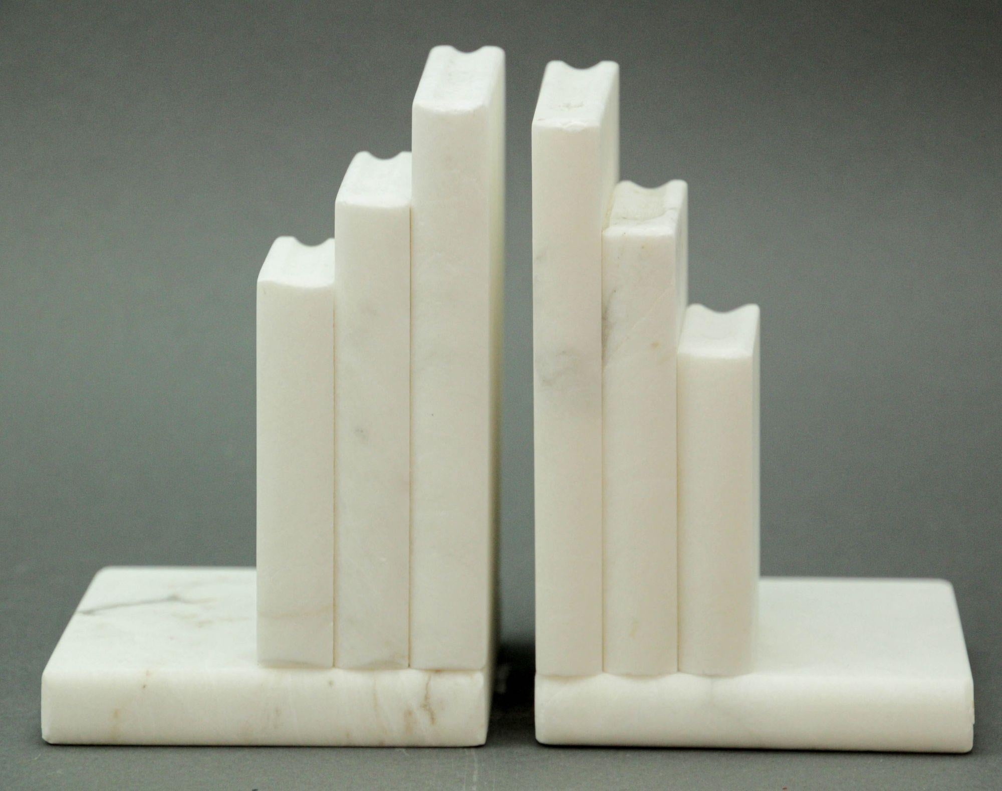 Pair vintage Post Modern white hand carved marble bookends, handmade in Italy, 1970s.
Pair of hand carved Italian Carrara marble in the shaped of stalked books bookends.
They are handmade pure white natural color of the marble.
These are very