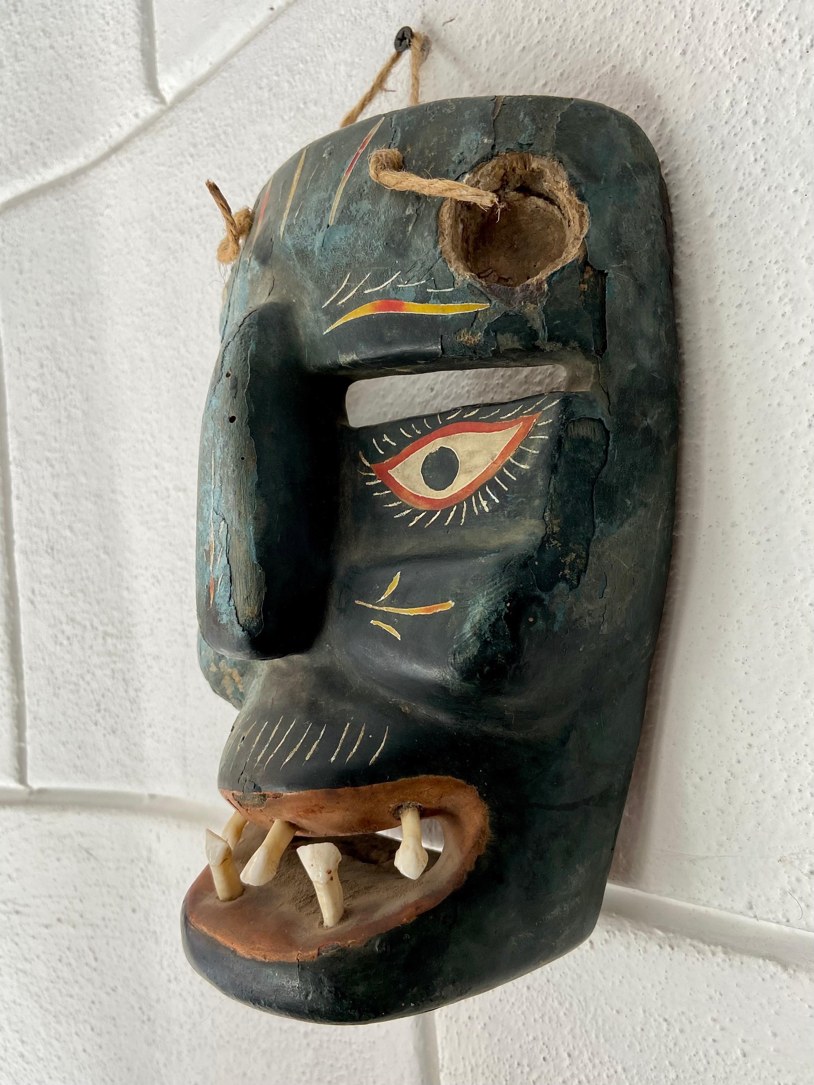 Hand-carved, hardwood ceremonial mask from the Uruapan / Patzcuaro region of Michoacan, Mexico, circa 1960's. This devil mask once seen in representations of the nativity is of a deep blue/grey turquoise and bright, colorful maque inlays clearly