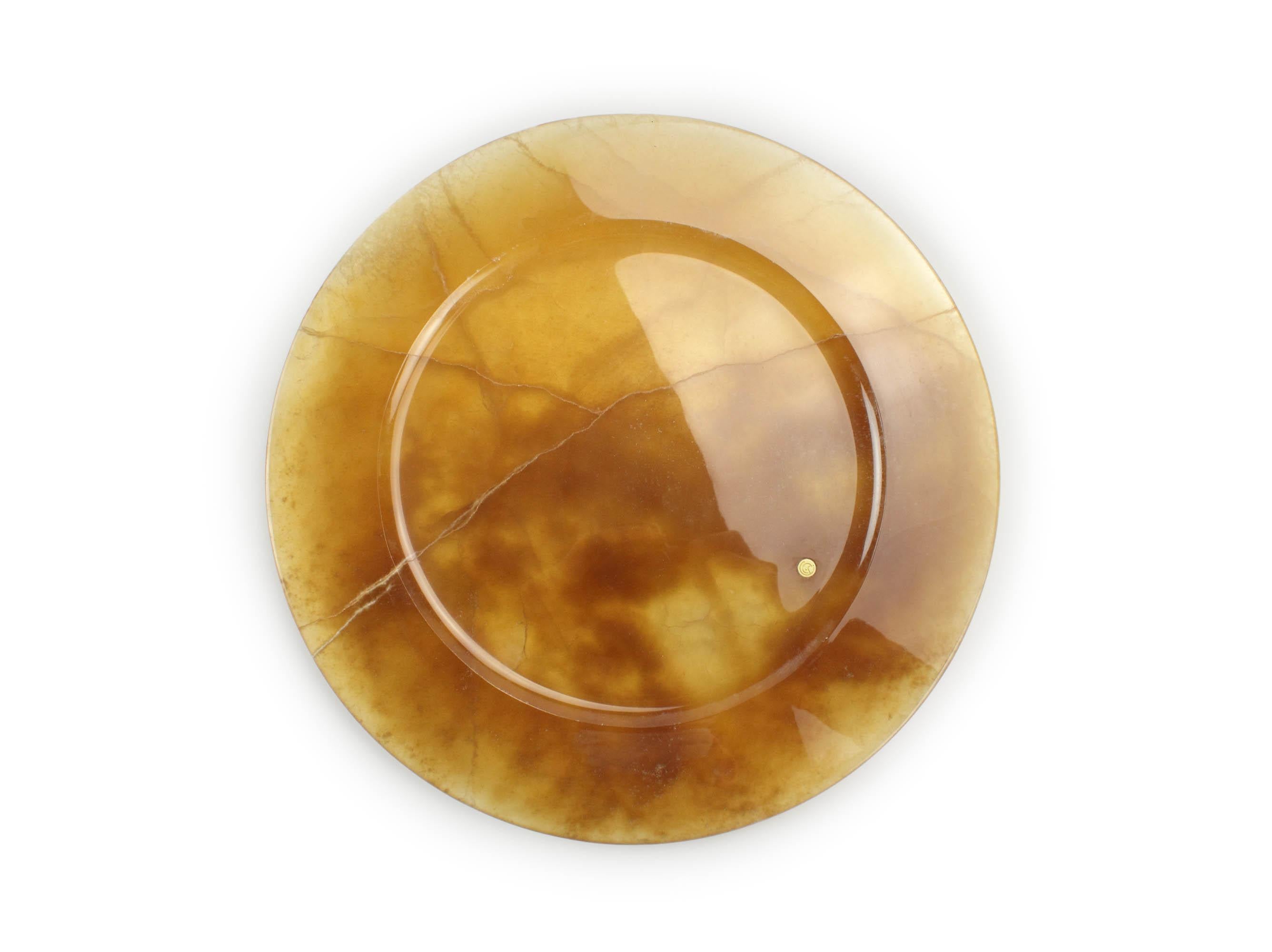 Hand carved charger plate from Amber onyx. Multiple use as charger plates, plates, platters and placers. The polished finishing underlines the transparency of the onyx making this a very precious object. 

Dimensions: D 33 x H 1.9 cm. Available in