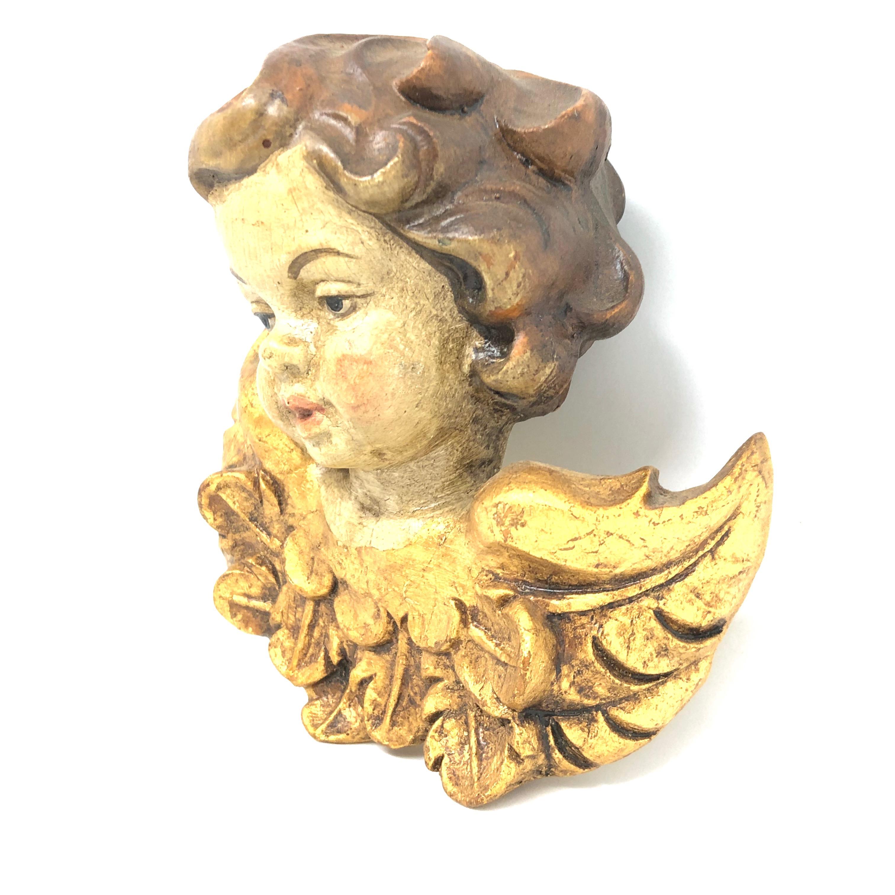 cherub head with wings