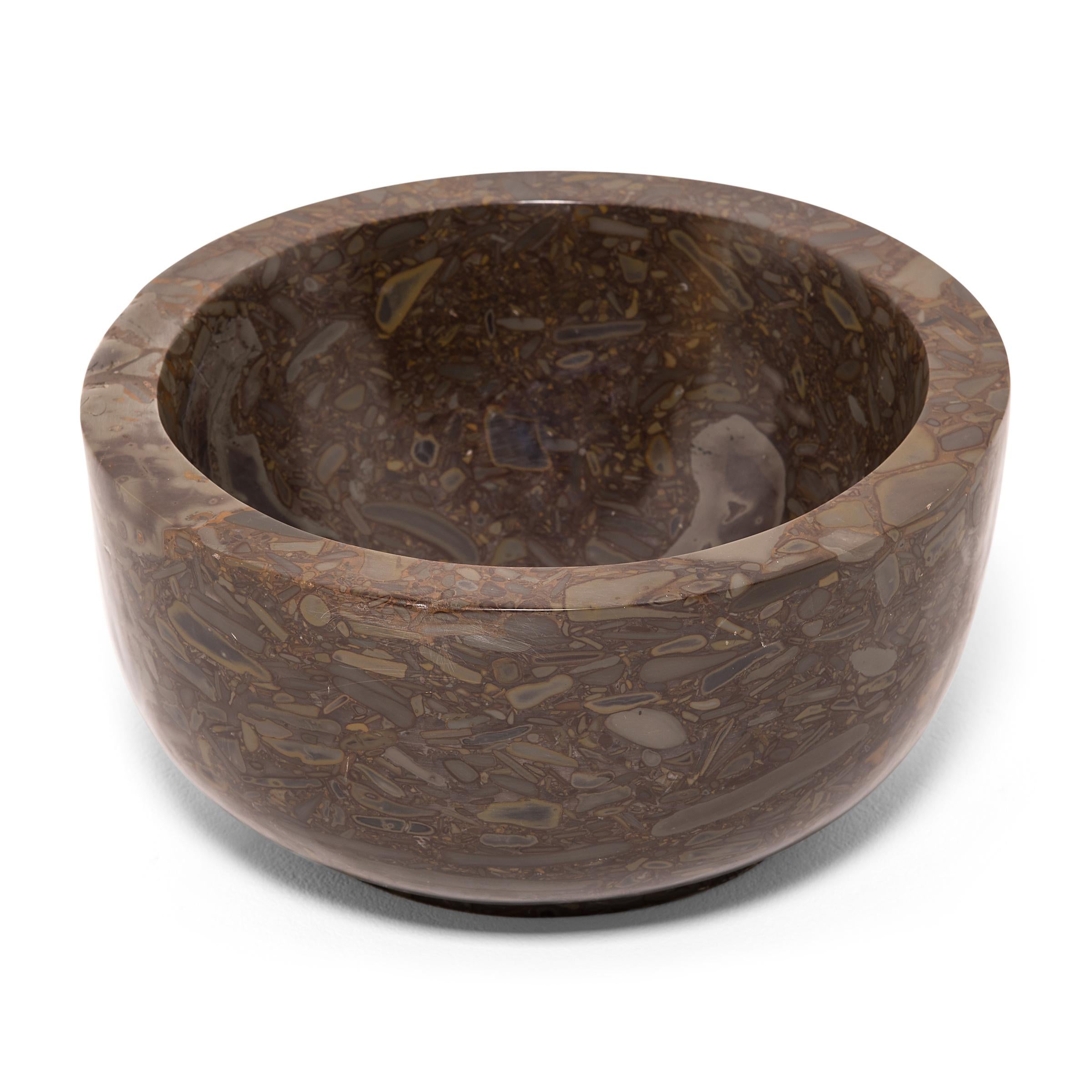 A clean-lined interpretation of an ancient form, this footed basin was hand-carved by artisans in China's Shandong province. It looks as if it were meticulously painted but the mesmerizing pattern of the puddingstone is actually inherent to the