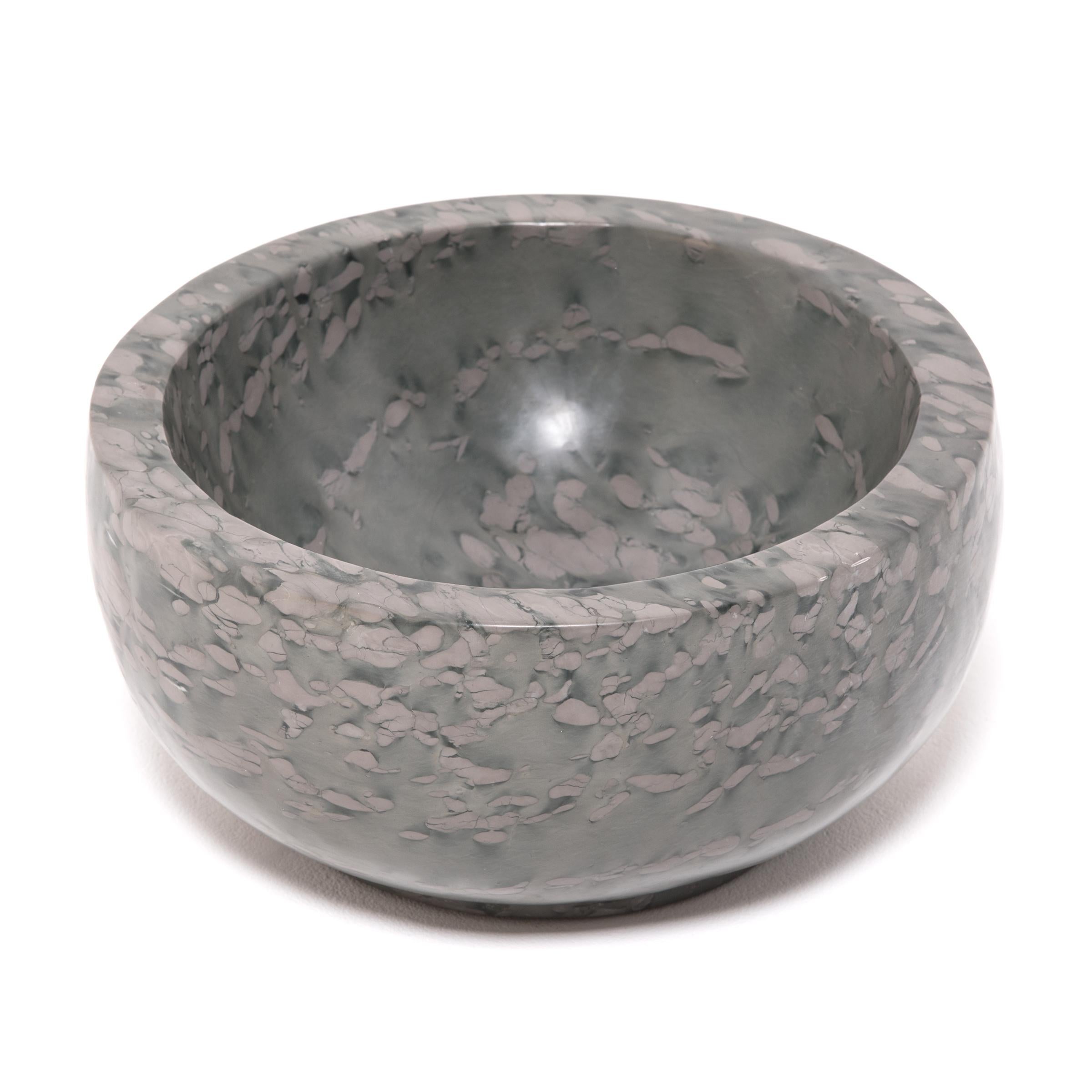 A clean-lined interpretation of an ancient form, this footed basin was hand-carved of zhenzhu stone by artisans in China's Shandong province. It looks as if it were meticulously painted but the mesmerizing pattern of the zhenzhu is actually inherent