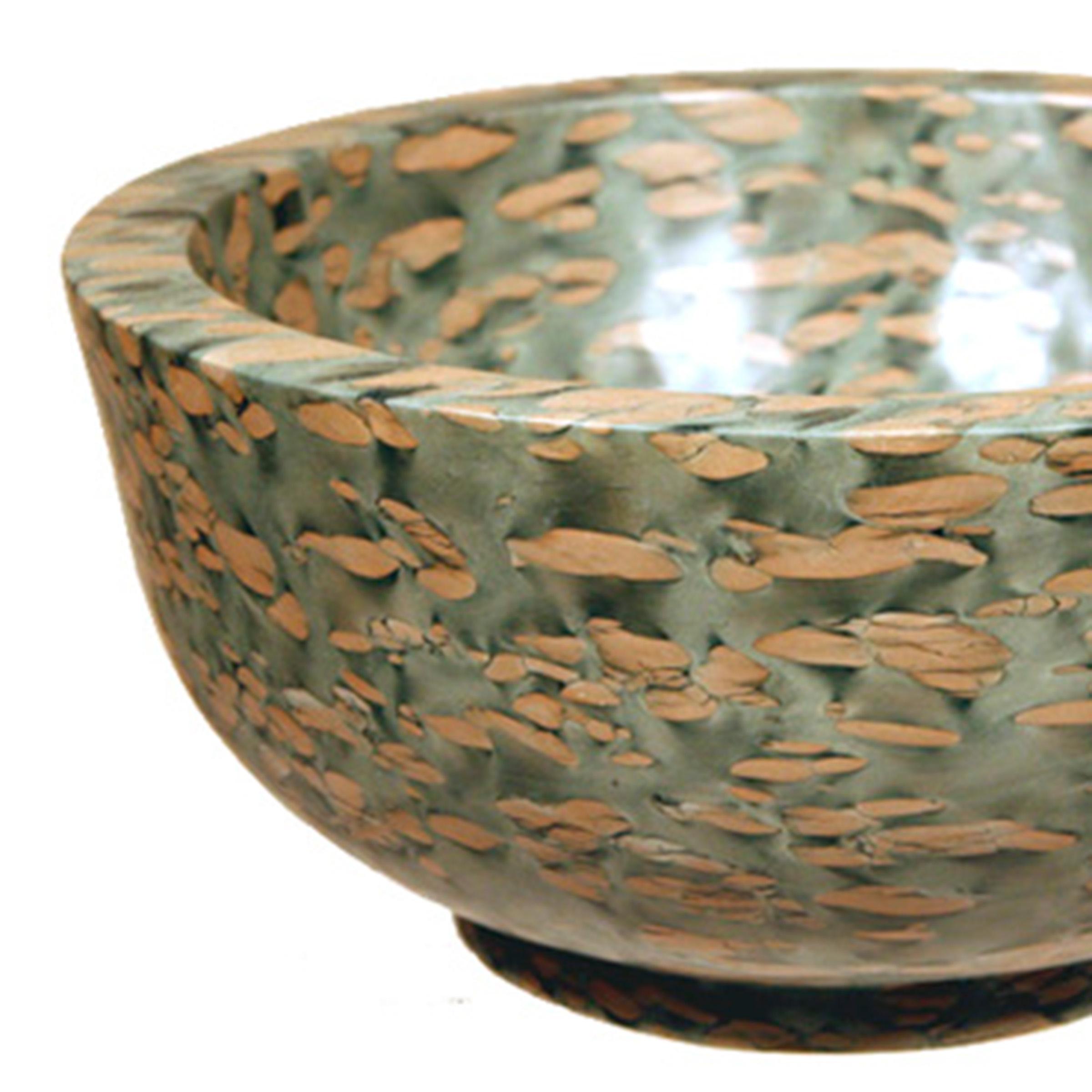 A clean-lined interpretation of an ancient form, this footed basin was hand-carved by artisans in China's Shandong Province. It looks as if it were meticulously painted but the mesmerizing pattern of the puddingstone is inherent to the stone, a