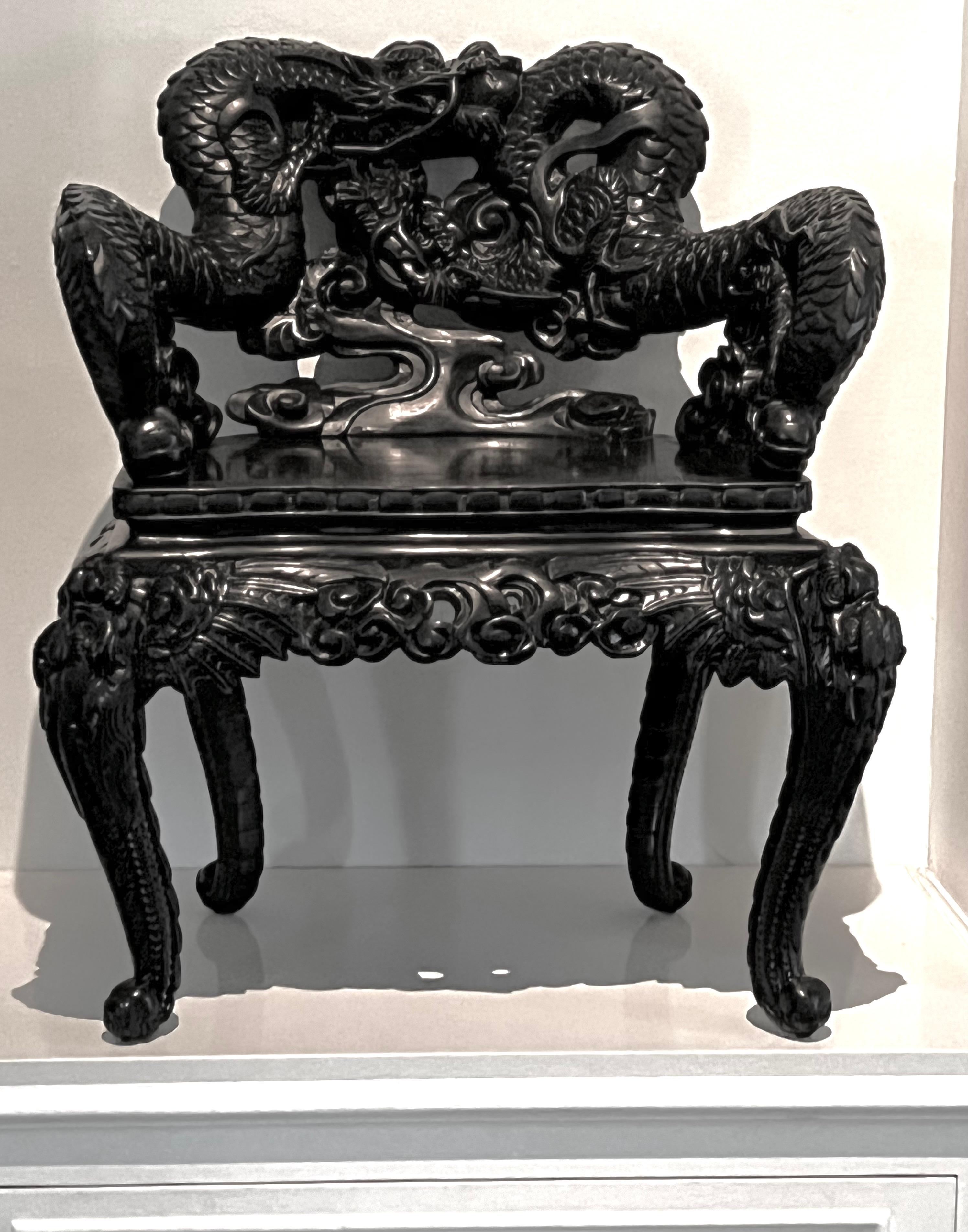 A beautiful representation of Chinese craftsmanship. Hand carved with dragons and bats, a unique piece that will make a wonderful side chair or focal point in many spaces from traditional to modern. Definitely a conversation piece with many