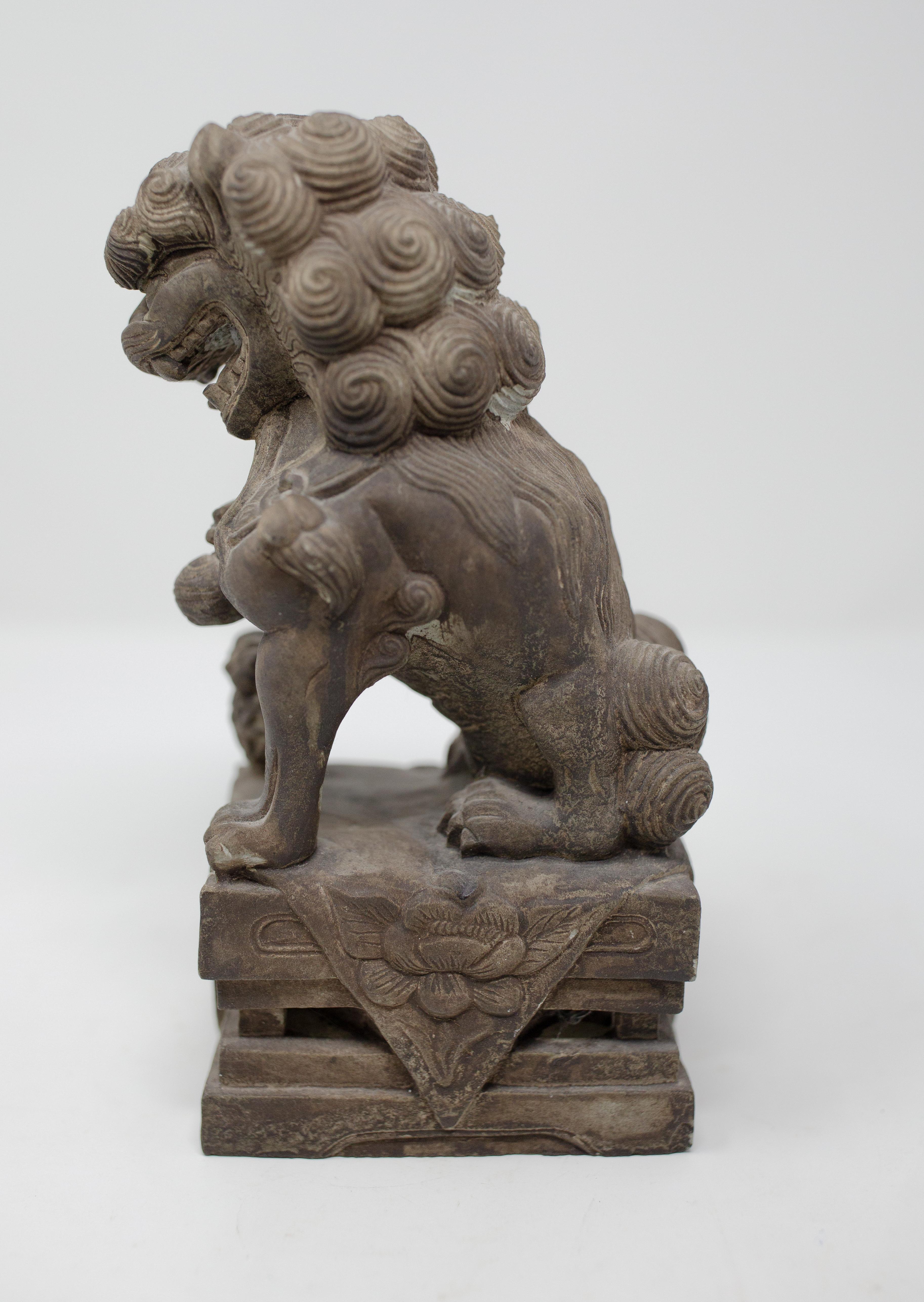 Offering this stunning hand carved Chinese stone foo dogs. Hand carved with all the intricate details on the body of the foo dog. The foo dog is in its standard pose with one foot on a ball. The base has geometric designs with floral motifs and