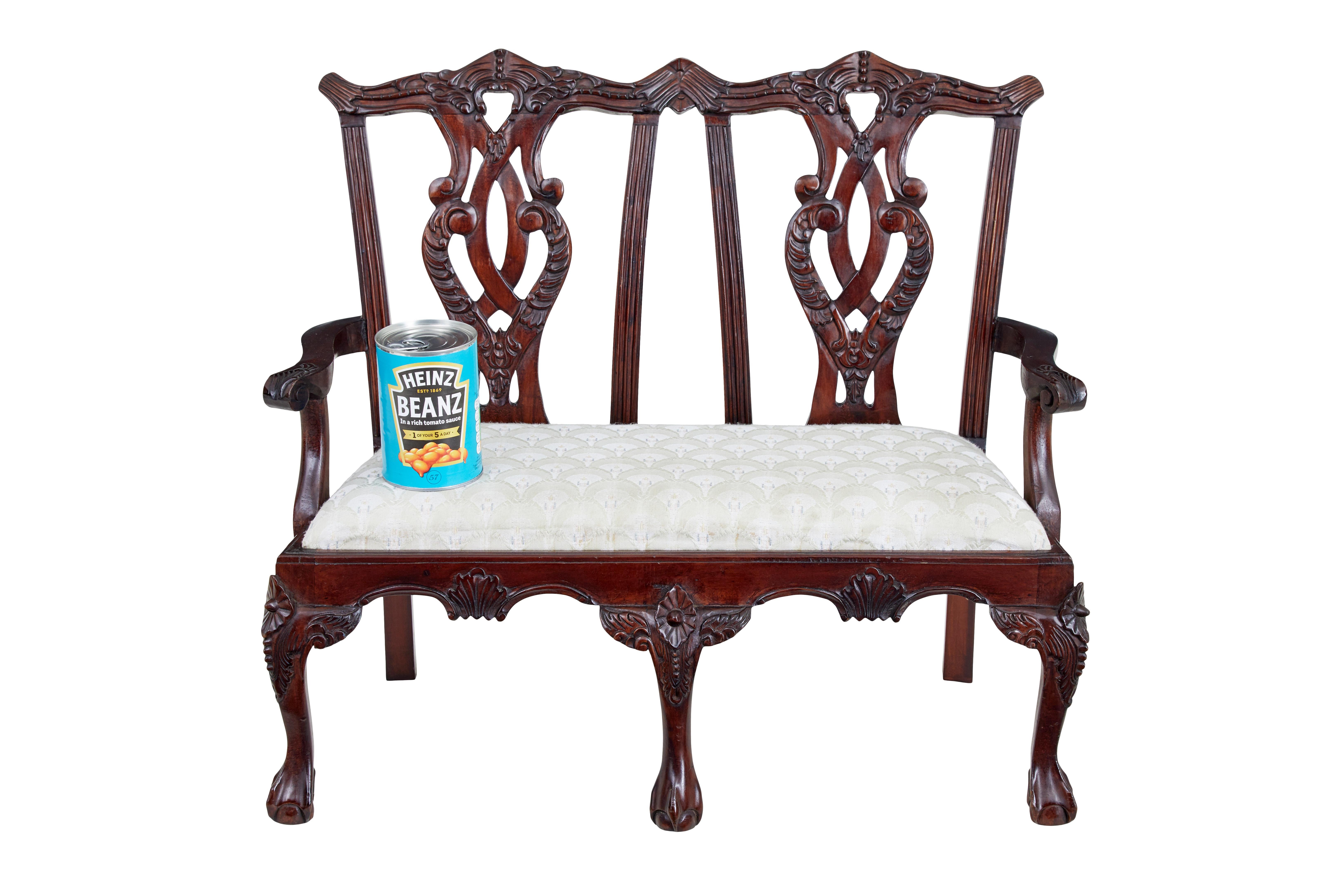 Hand carved Chippendale influenced miniature 2 seat chair circa 1990.

Here we have a fine example of a well known Chippendale design double seated chair.  Well carved in fruitwood showing all detailed carving, all presented in this scale.  This