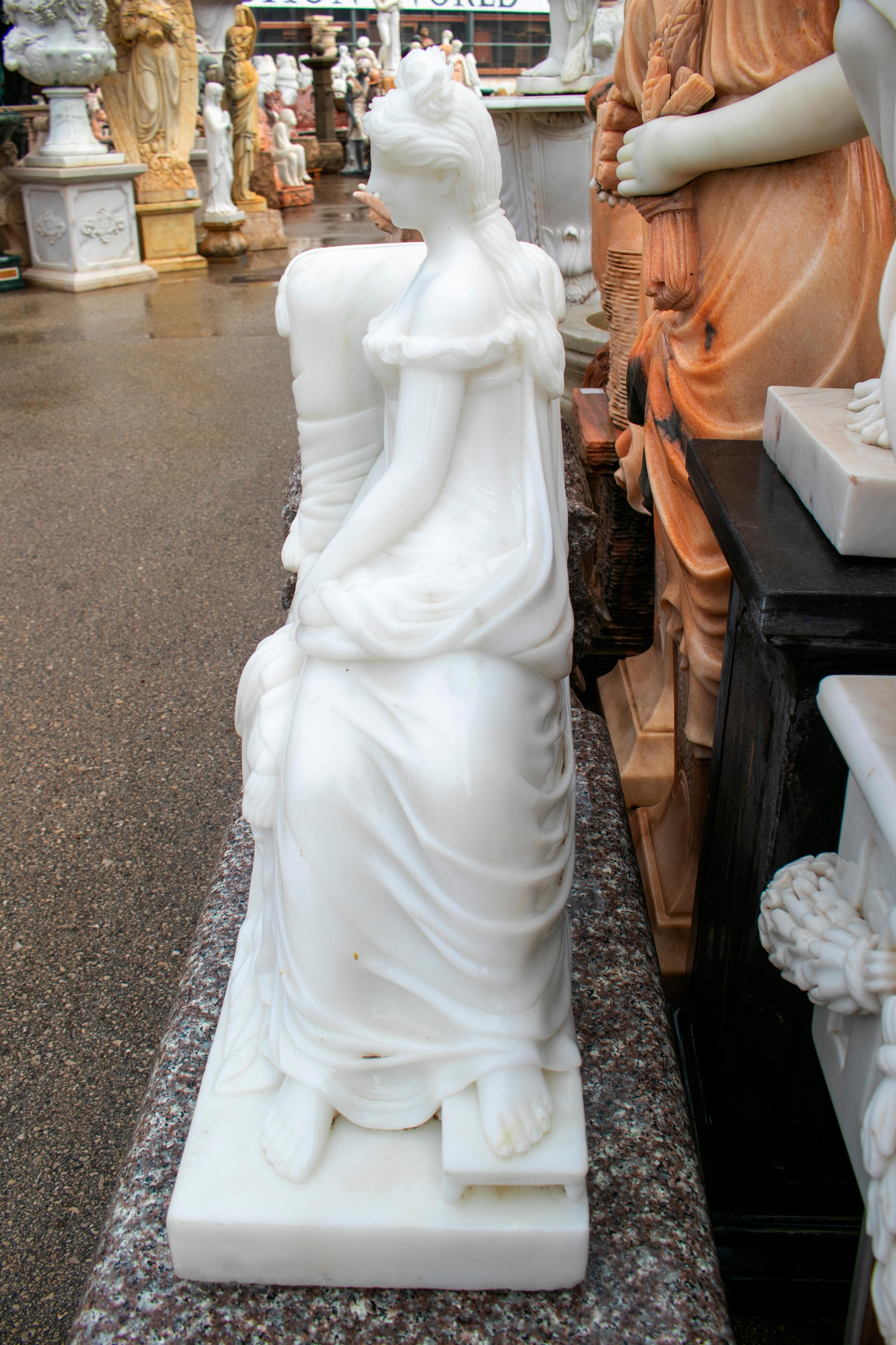 European Hand Carved Classical White Marble Lady Sitting on a Chaise Lounge For Sale