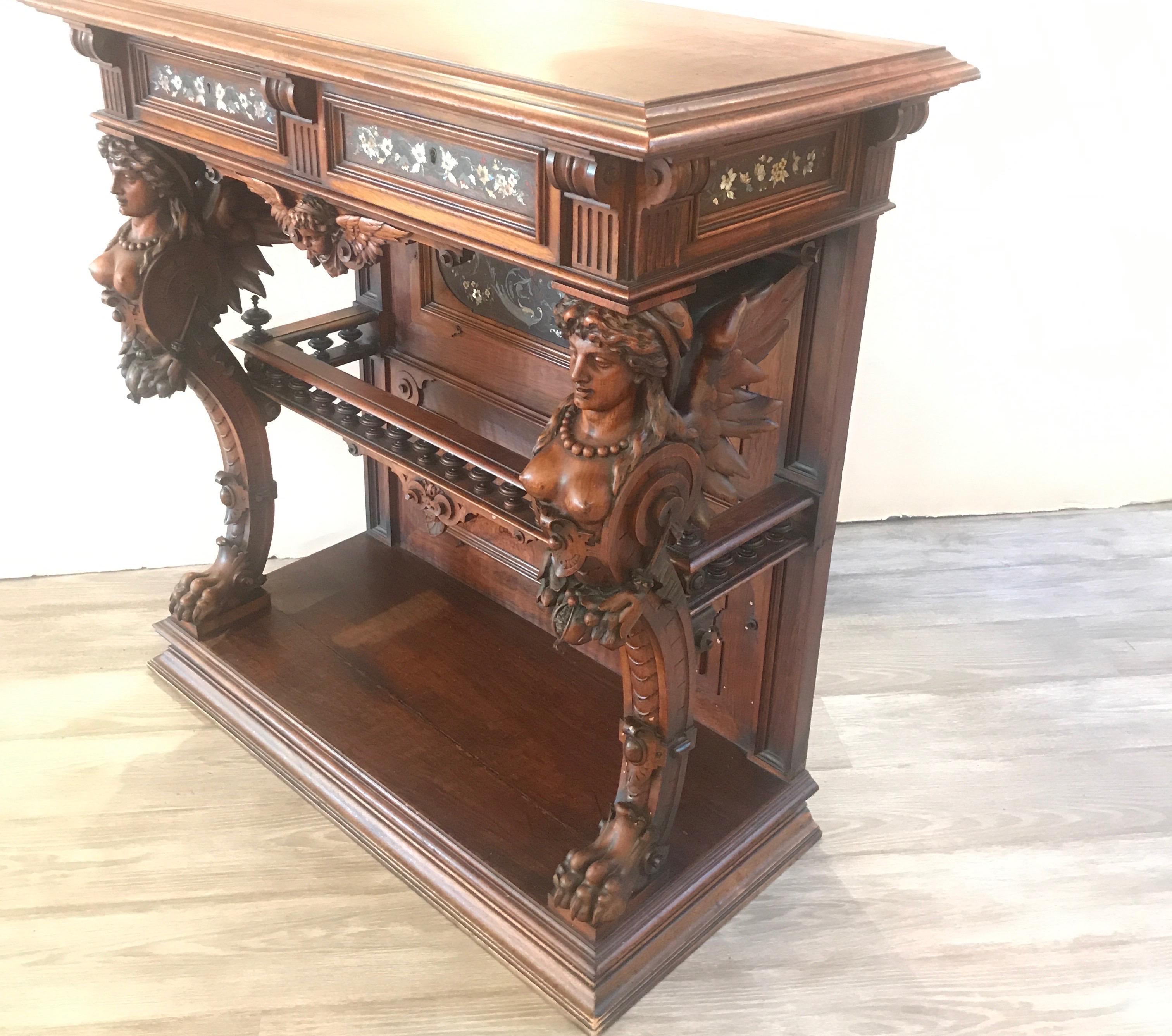 A hand carved walnut console or pier style table attributed to Herter Brothers. The drawer fronts and lower panel with mixed inlaid highly detailed decoration. Measures: 37.25 high, 38 wide, 18.25 deep. The firm of Herter Brothers, (working