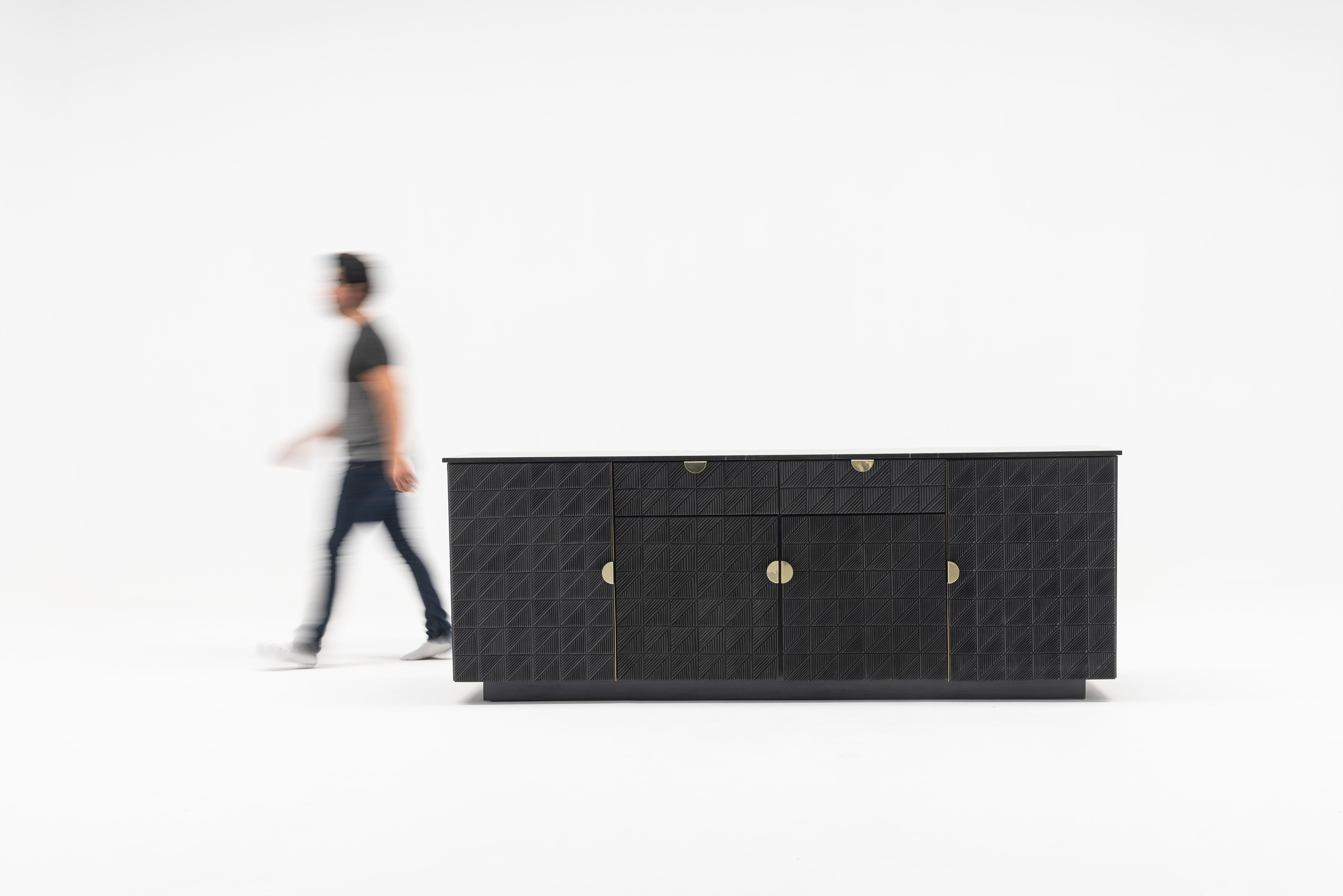 This credenza is a piece to touch, the ideal accent for a space with a lot of personality. 

Its fronts carved by hand in solid cedar wood with a black finish, generate a sensory experience with its impressive reliefs made with master