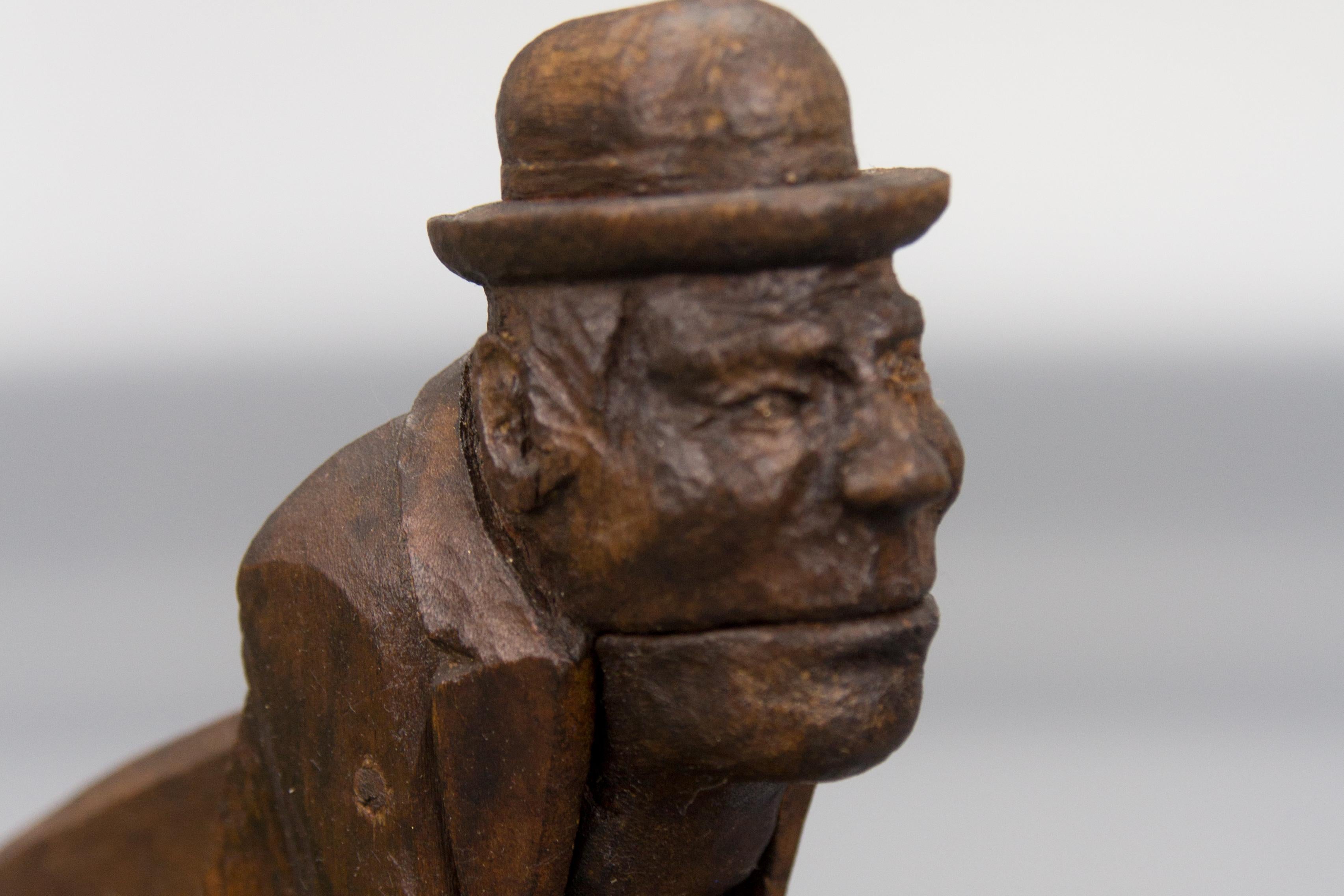 Mid-20th Century Hand Carved Dark Brown Wooden Figural Nutcracker of a Man, Germany, 1930s For Sale