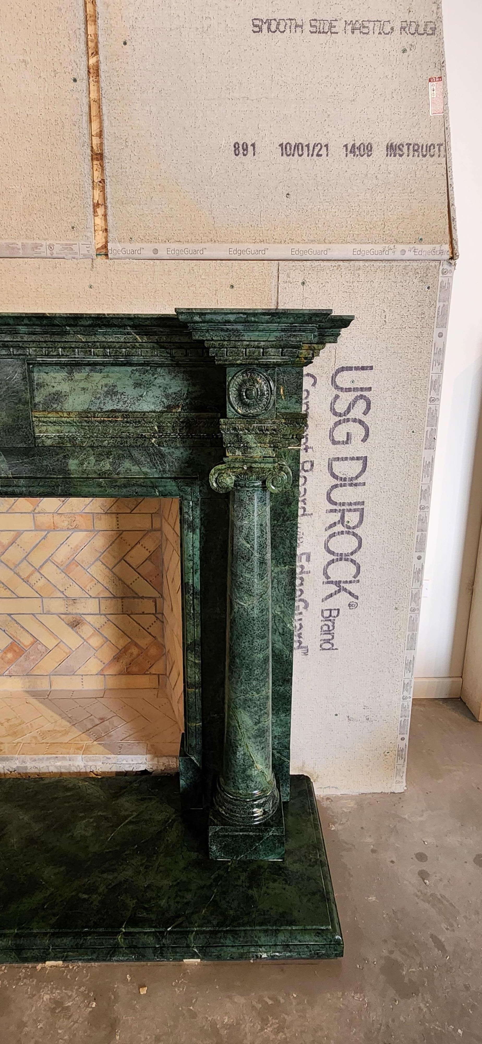 This exquisitely-carved, deep green marble fireplace, done in the style of the classical Georgian period, would be a perfect focal point for an elegant Study, Library, or Living Room.  The green marble is interspersed with deeper green veining, with