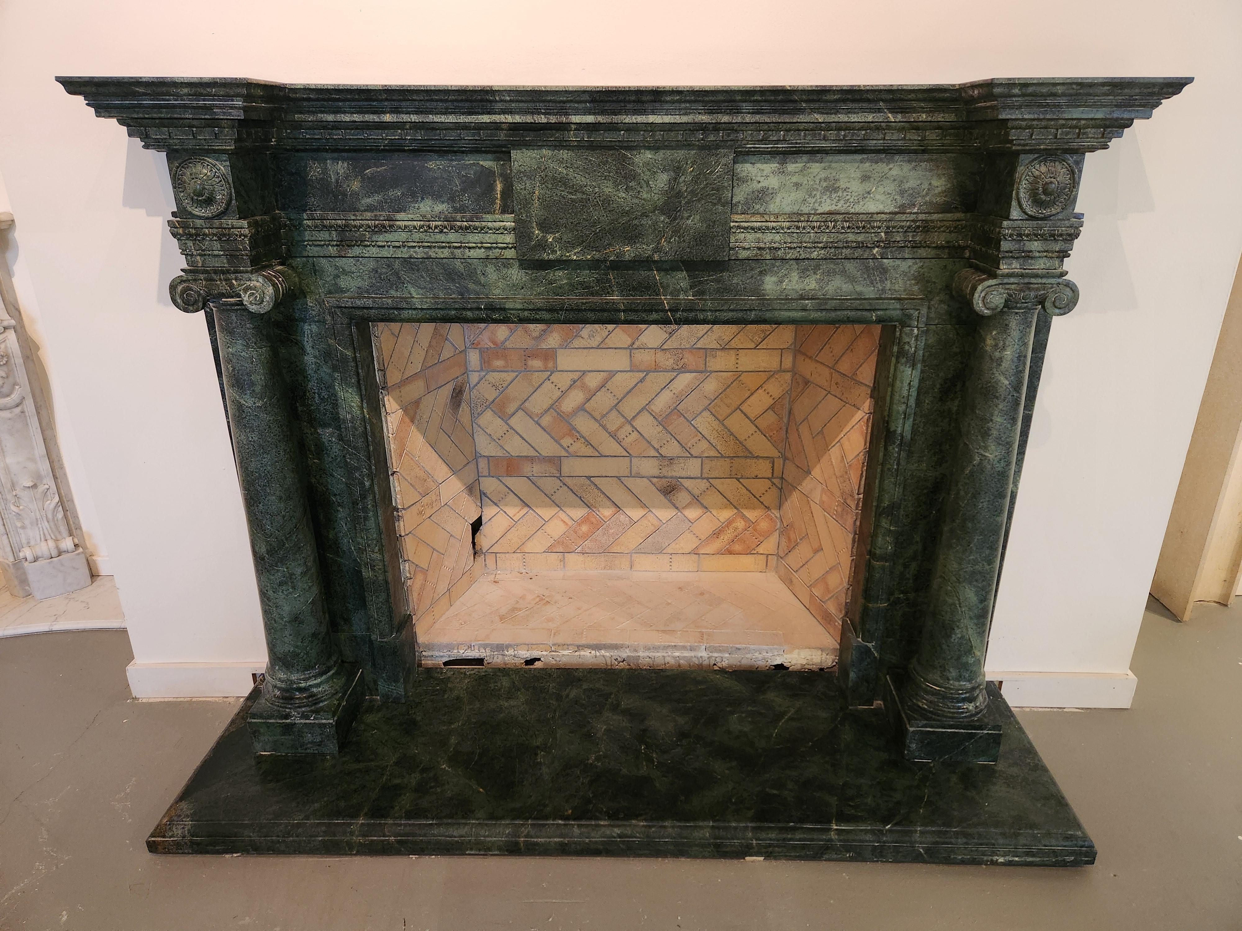 This exquisitely-carved, deep green marble fireplace, done in the style of the classical Georgian period, would be a perfect focal point for an elegant Study, Library, or Living Room.  The green marble is interspersed with deeper green veining, with