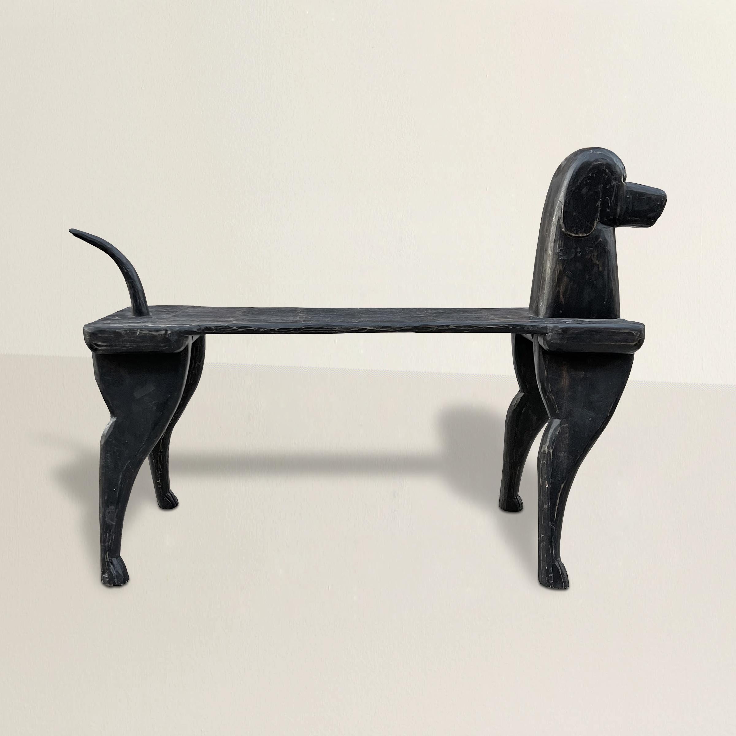 A wonderfully whimsical late 20th century hand carved wood dog bench by artist, Stephen Huseck. The bench features a rough hewn seat with a four legs, and movable tail, and a dog head with a sweet disposition. Perfect for extra seating in front of