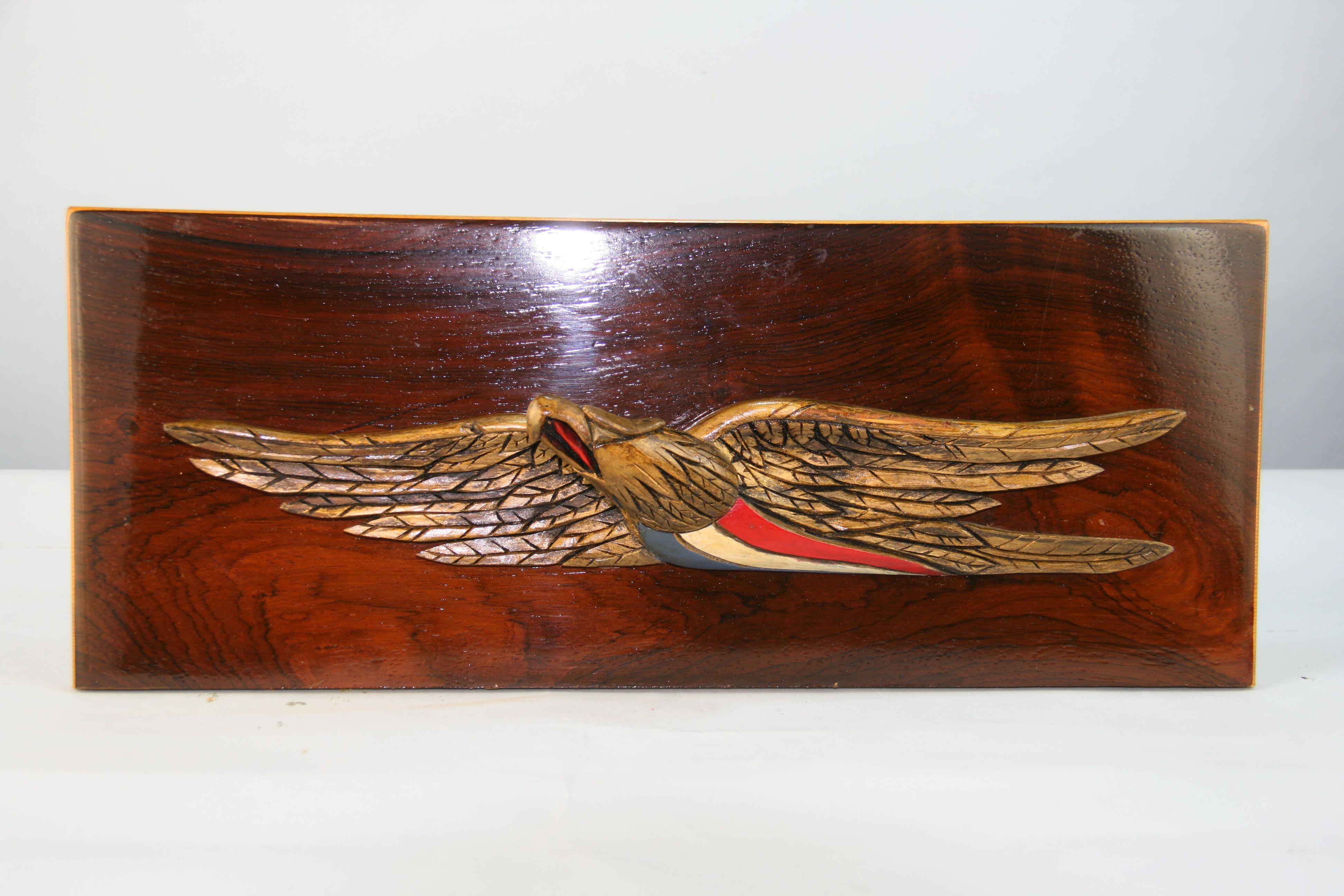 Hand carved wood eagle applied to wood panel.