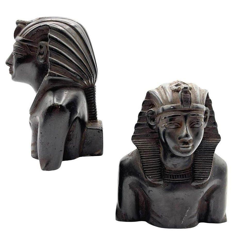Dated 1974 hand-carved King Tutankhamun bust bookends (set of 2), carved from a solid block of teak wood, feature detailed representations of the Pharaoh. The black finish highlights the design work and detailing. Each piece is signed by the artist
