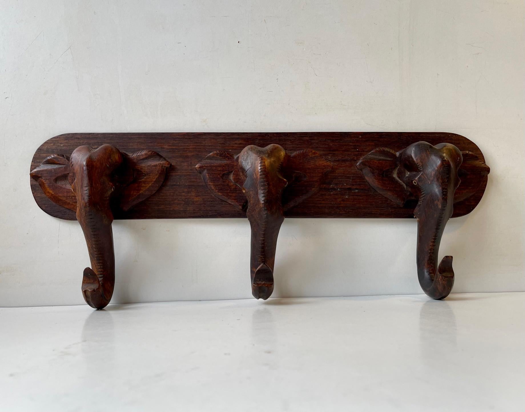Unusual rack for towels, handbags, hats, coats etc. Its hand carved in Dark wood with fine details. According to its previous owner his grandfather has ordered this piece locally in Denmark at a furniture maker. It has lost its teeth which are