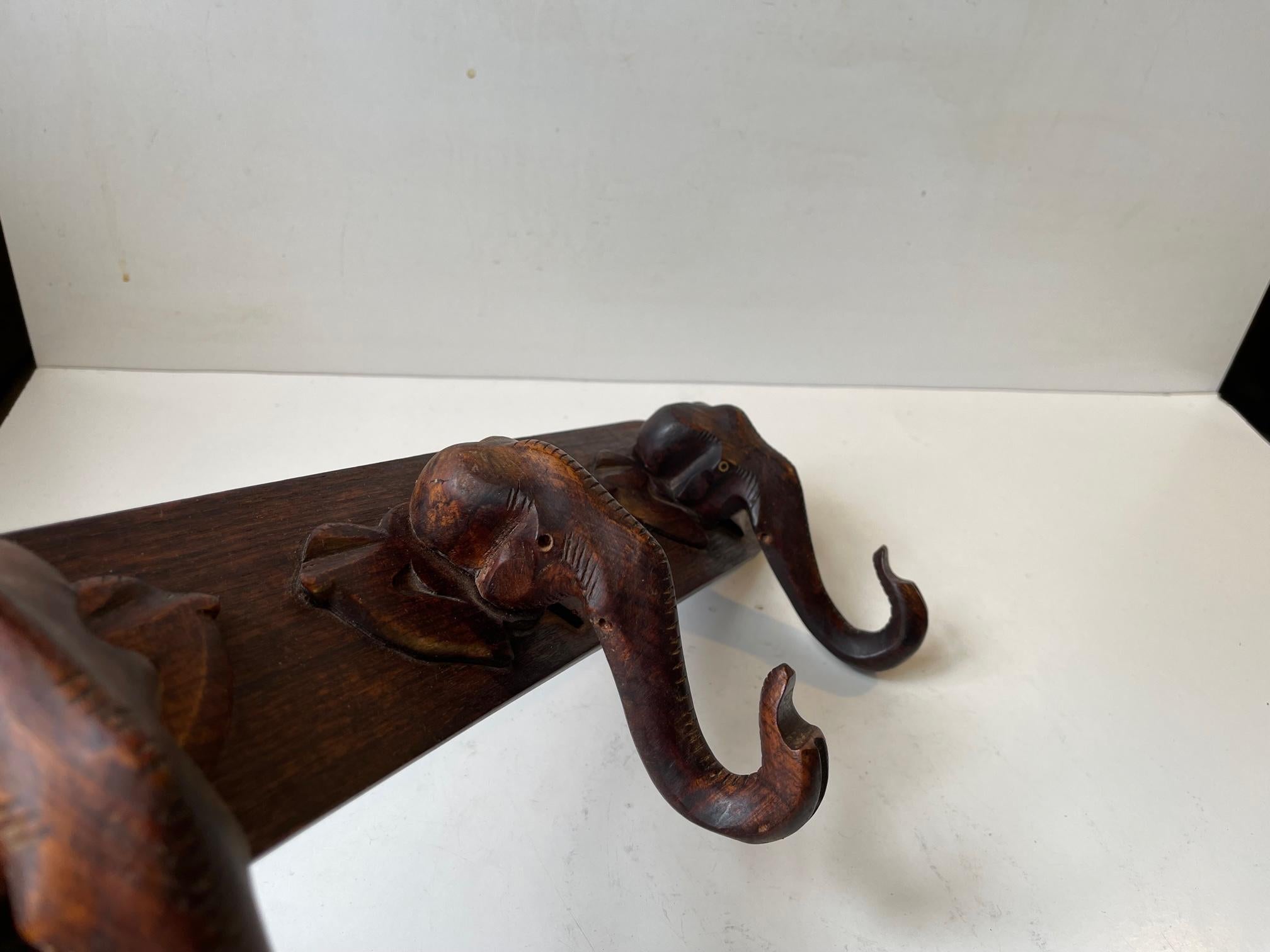 Mid-Century Modern Hand-Carved Elephant Coat or Towel Rack in Dark Wood, 1930s For Sale