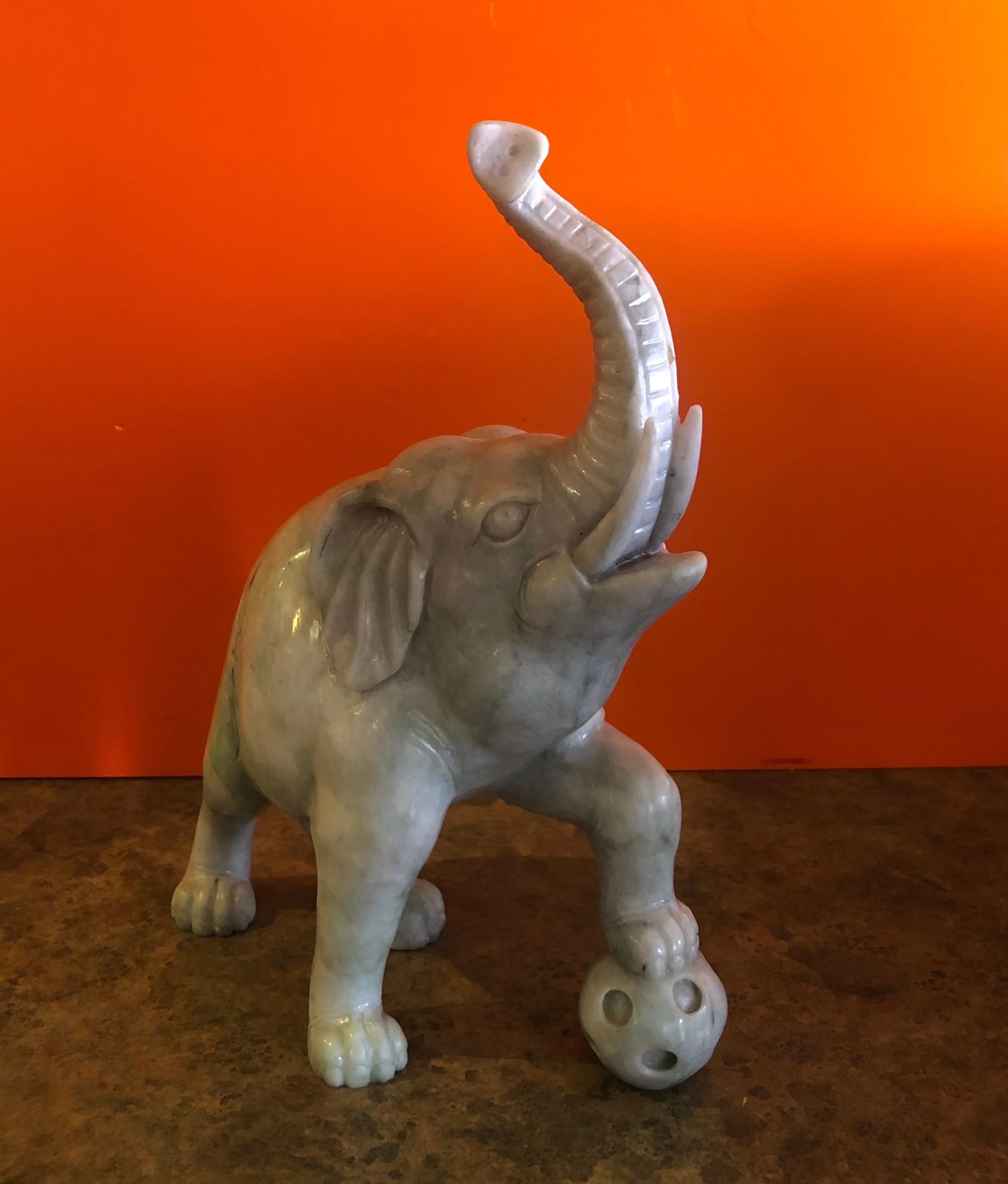 Gorgeous hand carved elephant sculpture in white jade, circa 1950s. Impressive detail and a stunning high gloss finish with deep veining. The piece is in excellent condition with no chips or cracks. The elephant measures: 9