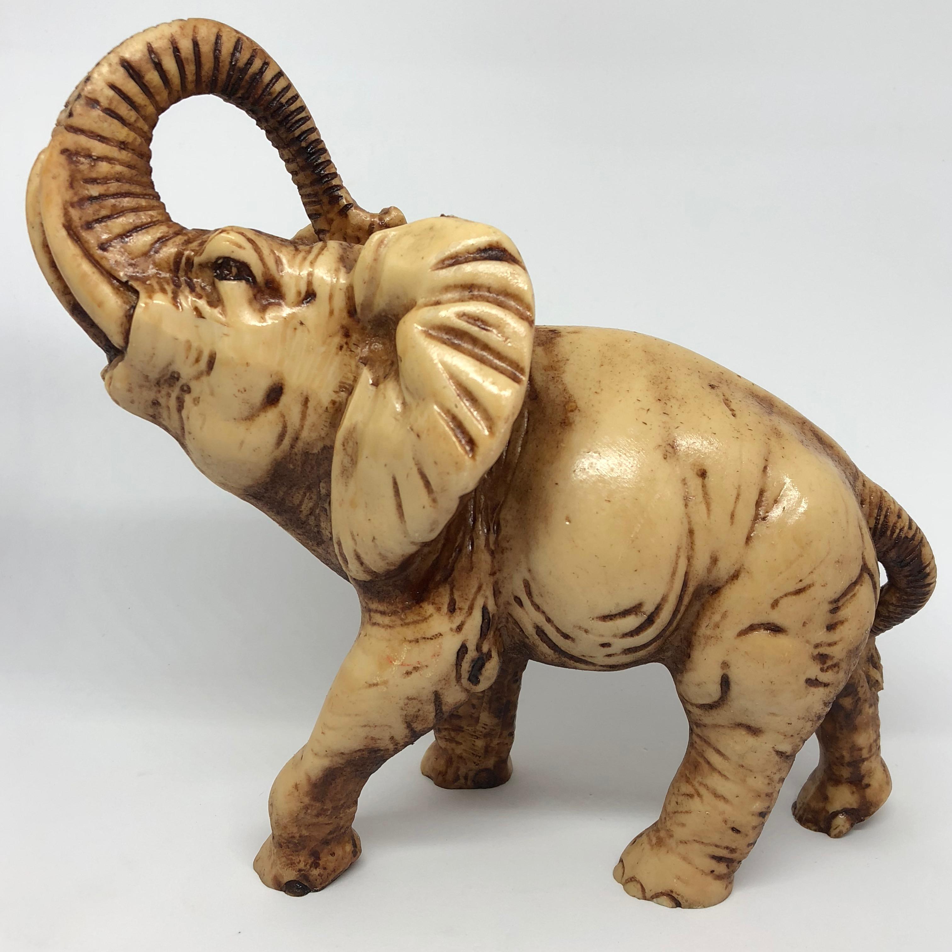 A decorative hand-carved elephant sculpture. Some wear but this is old-age. Made of a soapstone. We think it is from Europe and was made in the 1970s.