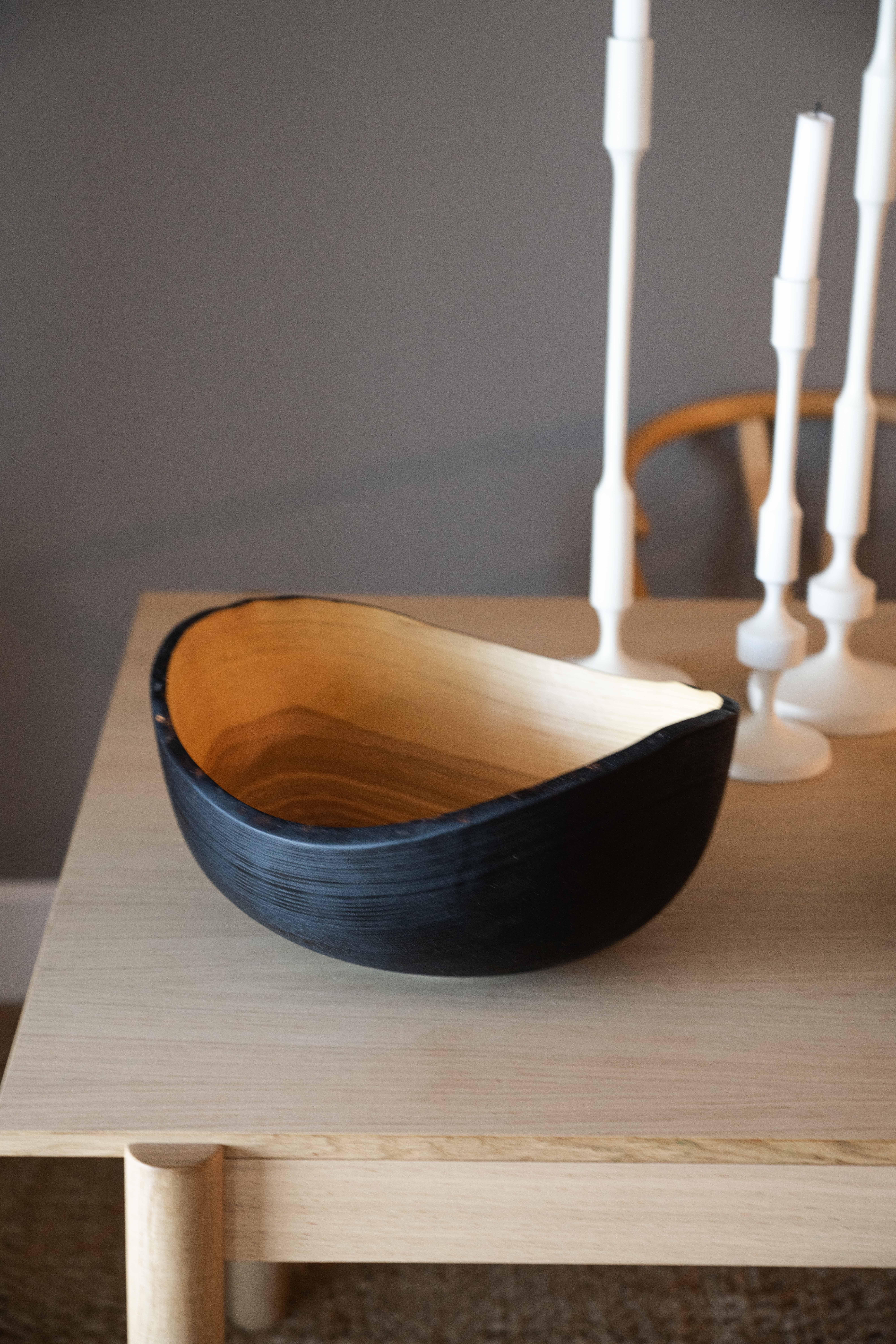 This large wood bowl will become a centerpiece on your table and a perfect vessel for all your fruits or vegetables in the kitchen. Hand-carved from one solid piece of ash wood, the shape continues the wooden rings and puts the age and the beauty of