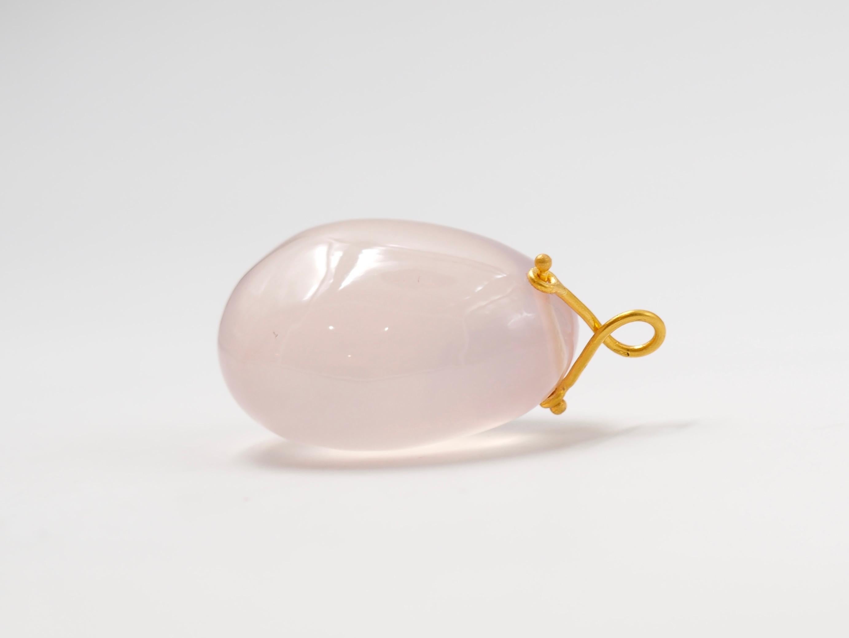 Hand-carved and handmade pendant, this stone is simply drilled to allow a 22 karat gold wire that is twisted to make a ring. 
The largest one, which is presented in the photos, has a rose quartz of approx 170 carats. 
3 stone sizes exist as you can