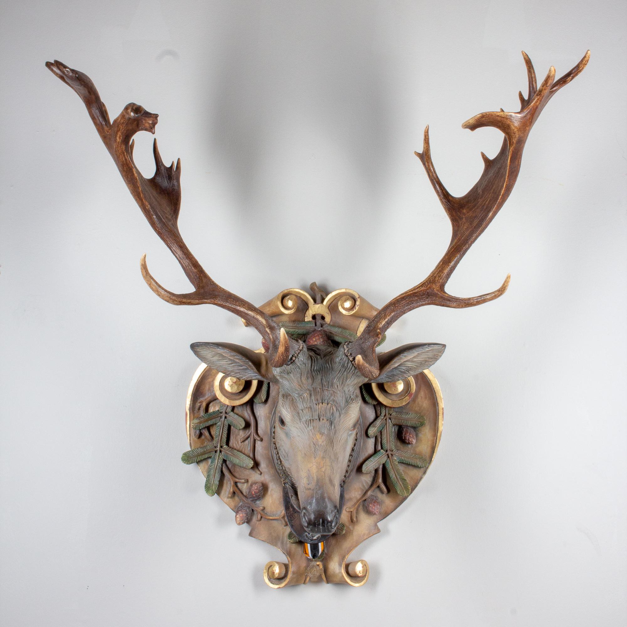 A stunning and very lifelike hand-carved linden wood Fallow deer with Italian polychrome painting technique with antique Habsburg antlers from the Eckartsau Castle of Emperor Franz Josef in the Southern Austrian Alps, a favorite hunting Schloss of