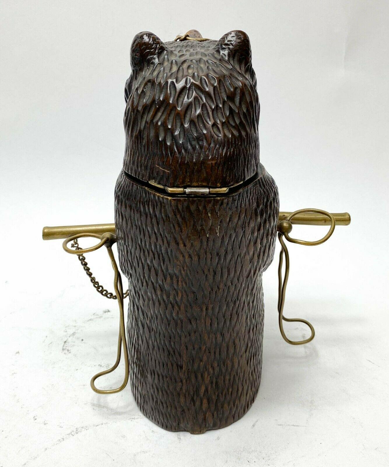 Hand carved figural bear Tobacco and Pipe stand, c1900

Stand modeled as a bear pipe and tobacco stand with 3 holders for pipes. The head opening container for tobacco. Likely a black forest bear. 

Additional information:
Dimension: 8.8 in. x