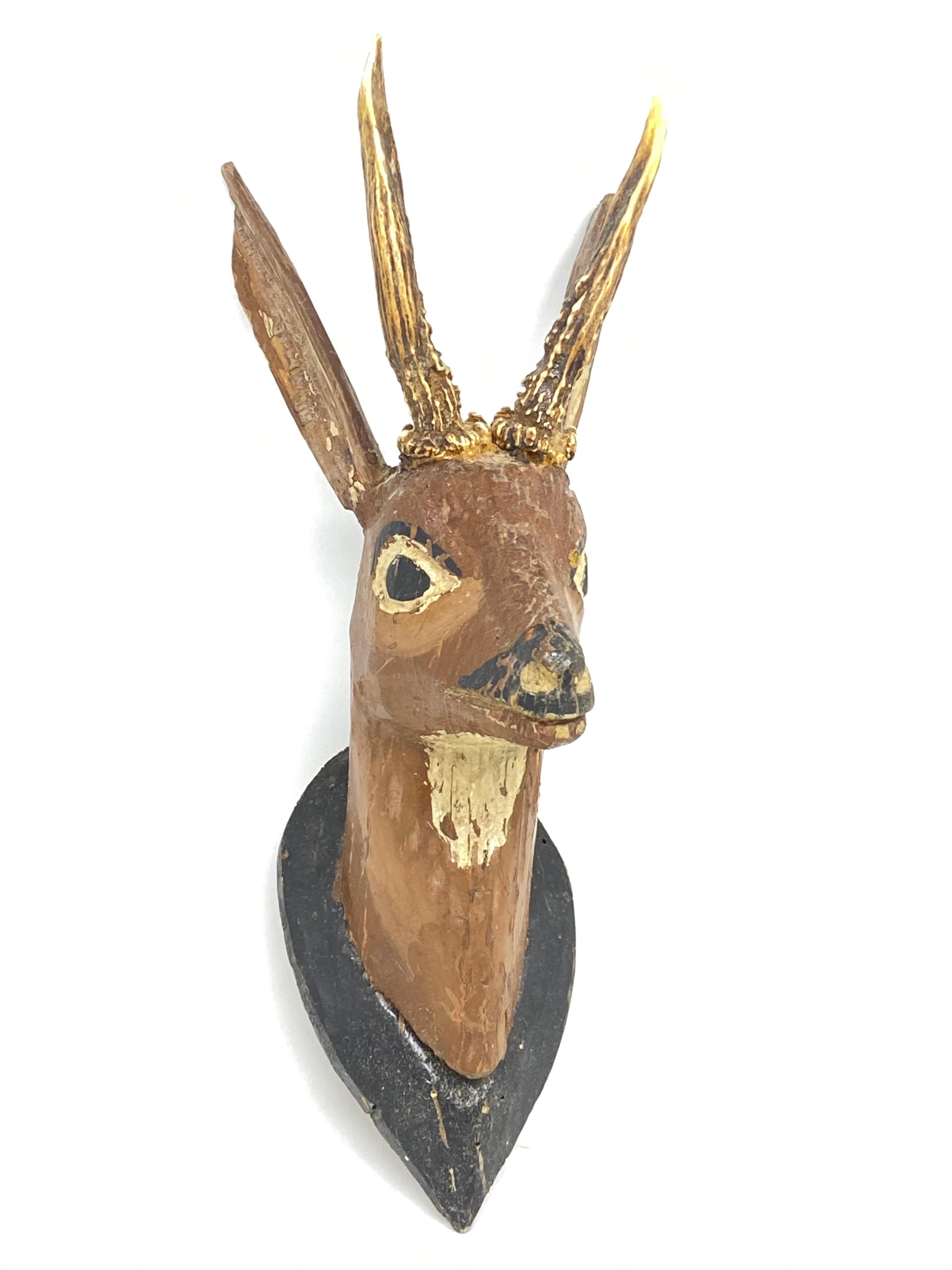 A great looking hand carved original wooden Folk Art deer head wall decoration. A great piece for a suitable ambiance in a trophy room or the office of a Hunter or Woodsman. More than likely one of the Folk Art items made between 1880 and the late