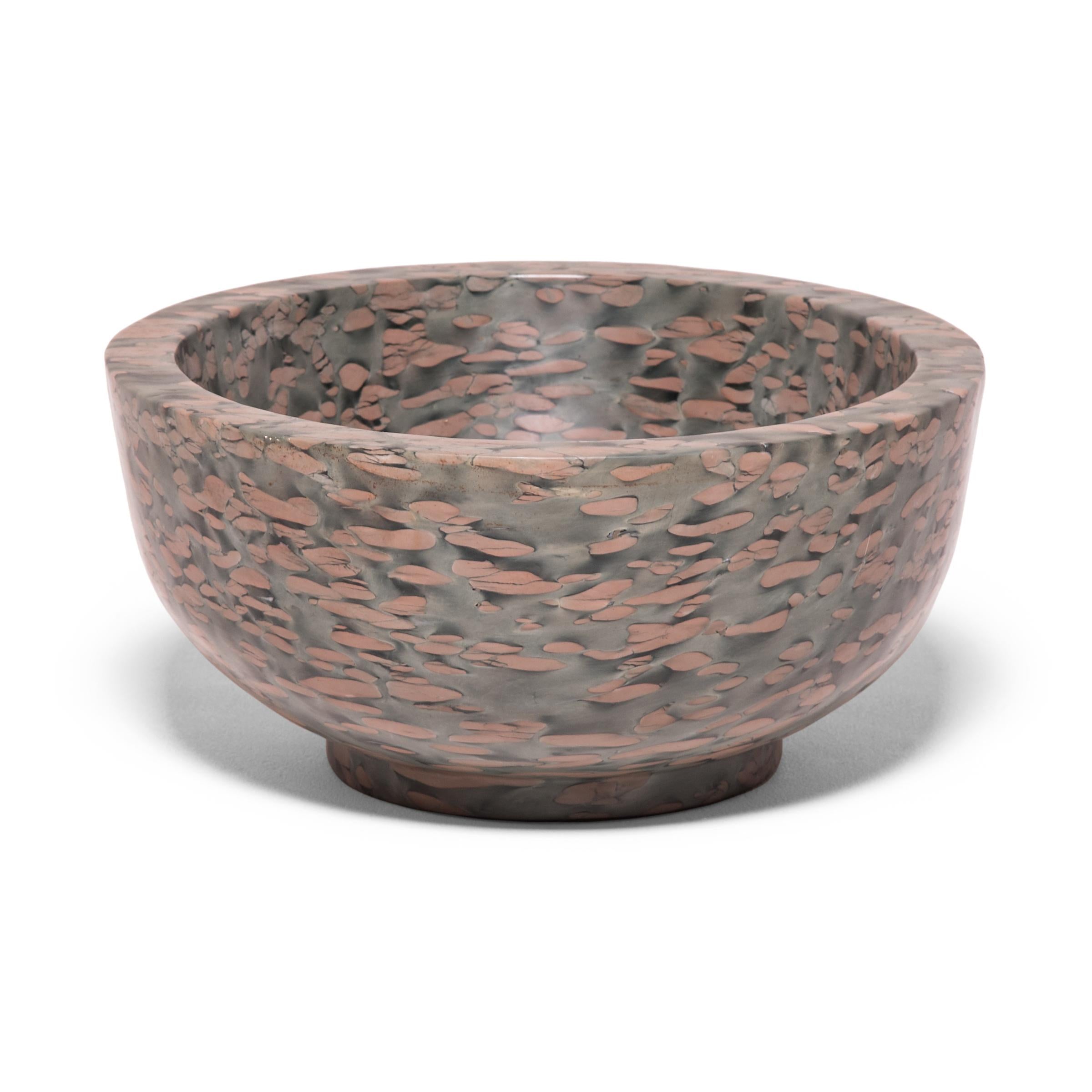 A clean-lined interpretation of an ancient form, this footed basin was hand-carved by artisans in China's Shandong province. The mesmerizing pattern of zhenzhu is inherent to the stone, a conglomerate limestone extracted from Lake Tai in Jiangsu