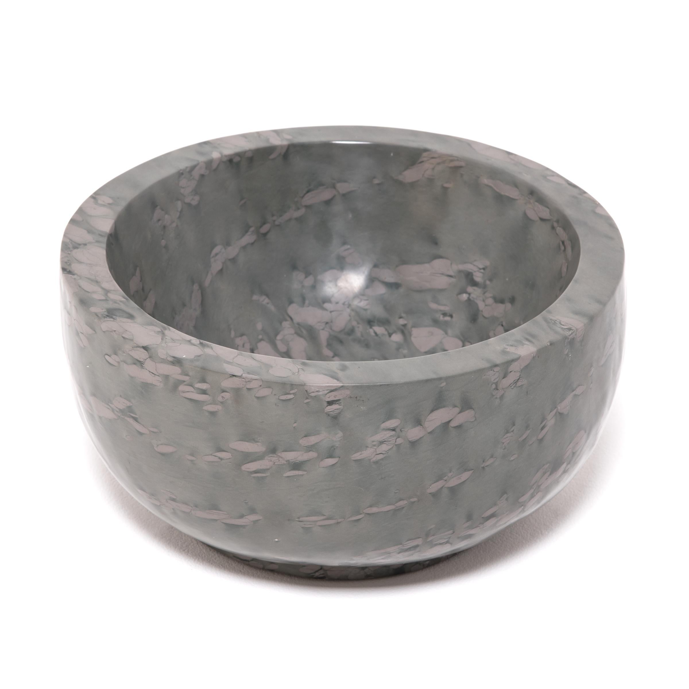 A clean-lined interpretation of an ancient form, this footed basin was hand carved by artisans in China's Shandong province. The mesmerizing pattern of zhenzhu is inherent to the stone, a conglomerate limestone extracted from Lake Tai in Jiangsu