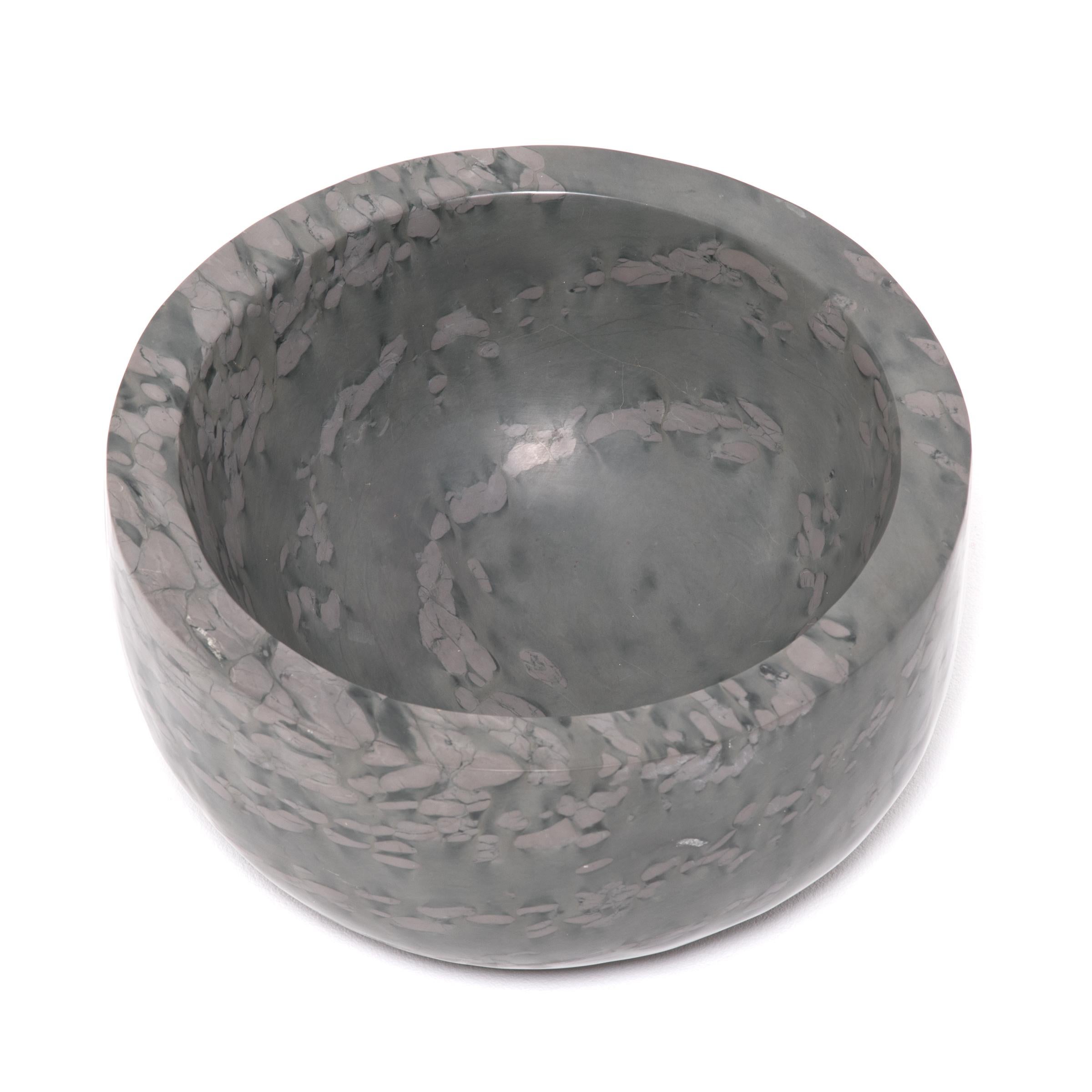 A clean-lined interpretation of an ancient form, this footed basin was hand carved by artisans in China's Shandong province. The mesmerizing pattern of zhenzhu is inherent to the stone, a conglomerate limestone extracted from Lake Tai in Jiangsu