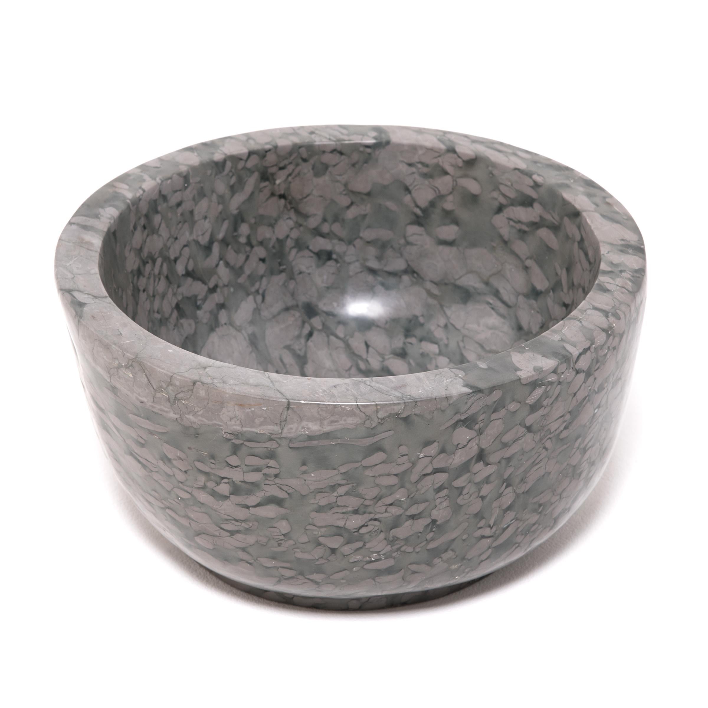 A clean-lined interpretation of an ancient form, this footed basin was hand carved by artisans in China's Shandong province. It looks as if it were meticulously painted but the mesmerizing pattern is actually inherent to the zhenzhu stone, a