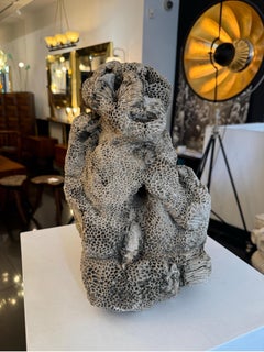 Natural brain coral in the form of a sitting monkey