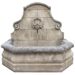 Hand Carved French Limestone Wall Fountain with Shell Motif and Sloped Shoulders