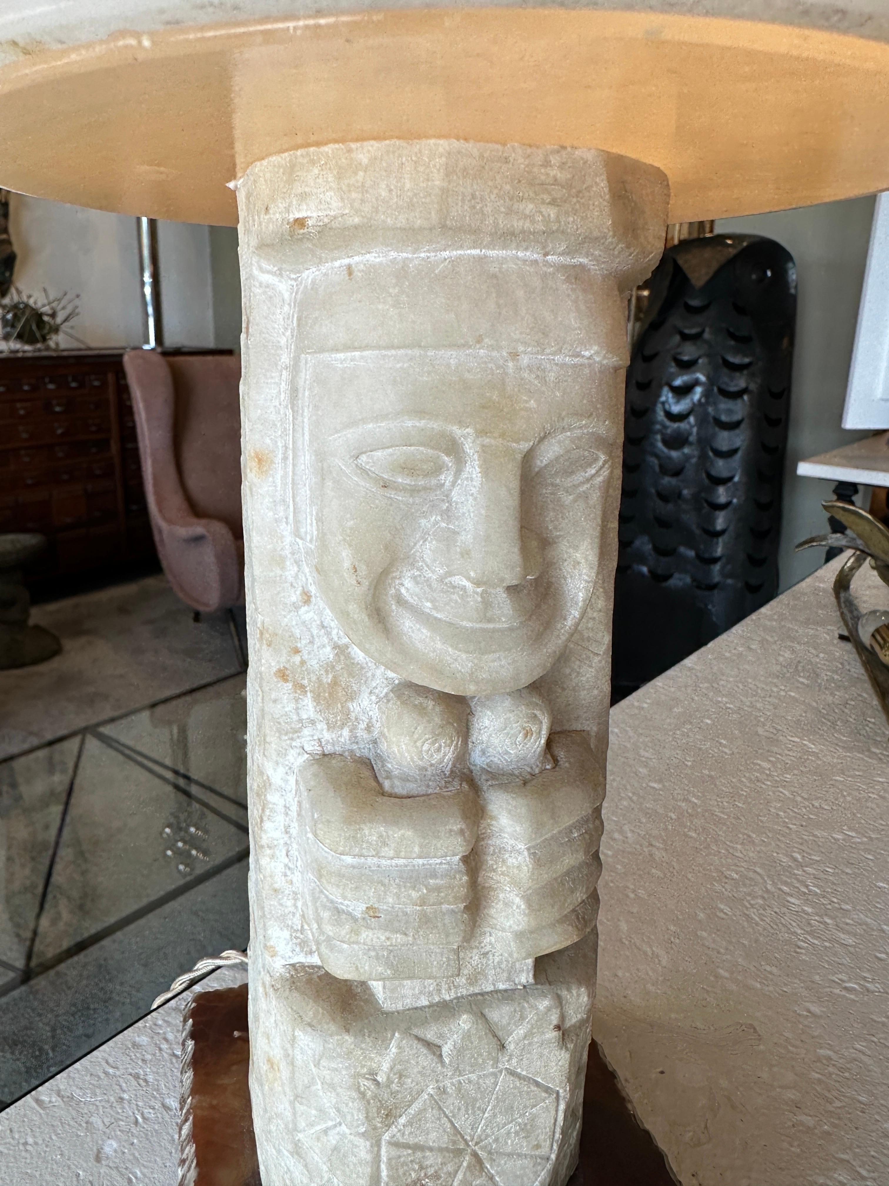 French Polynesian designed carvings on to the alabaster shade and body, this heavy and important table lamp has been professionally rewired with creamy silk cable and switch, as well as US outlet plug. A primitive Polynesian tribal design on a late