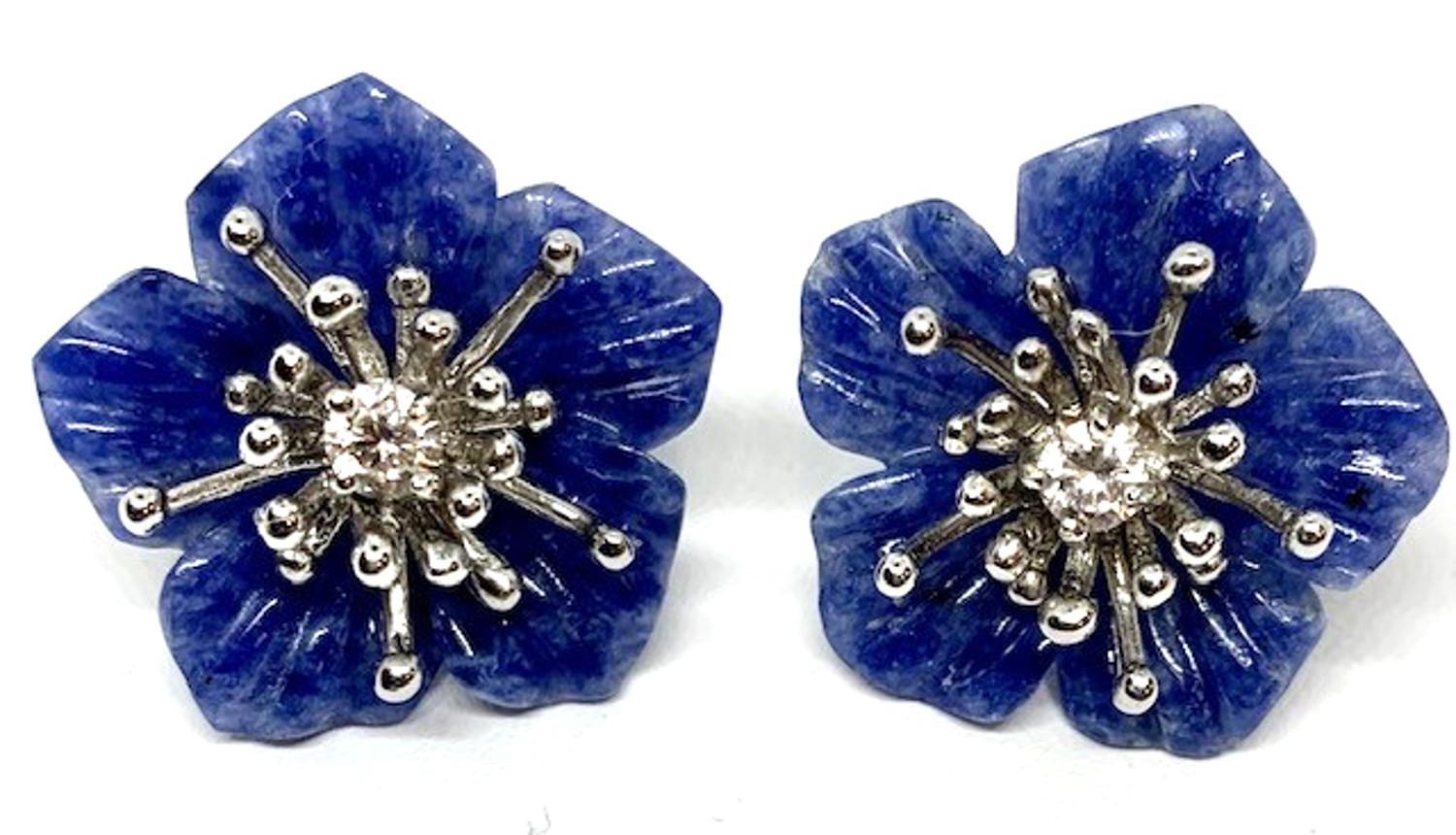 These interchangeable flower earring jackets are finely carved of sodalite, onyx, and mother-of-pearl. Worn with our 