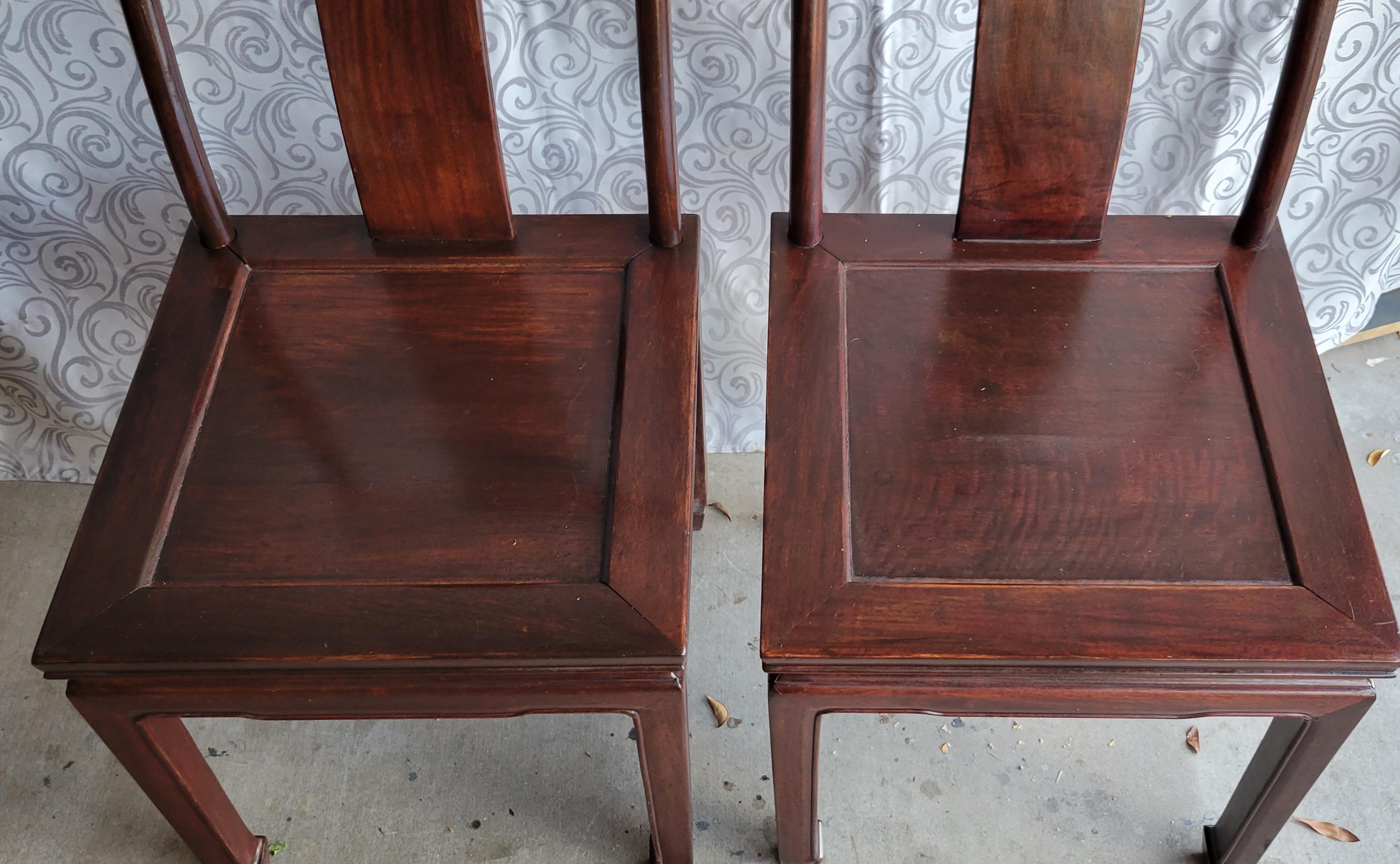 A set of 2 vintage solid wood side chairs in very good condition. We estimate that it was made sometime in the mid-20th century.  
Each chair has a delicate hummingbird and cherry blossom carving.  
The chairs have no maker's identifications, but