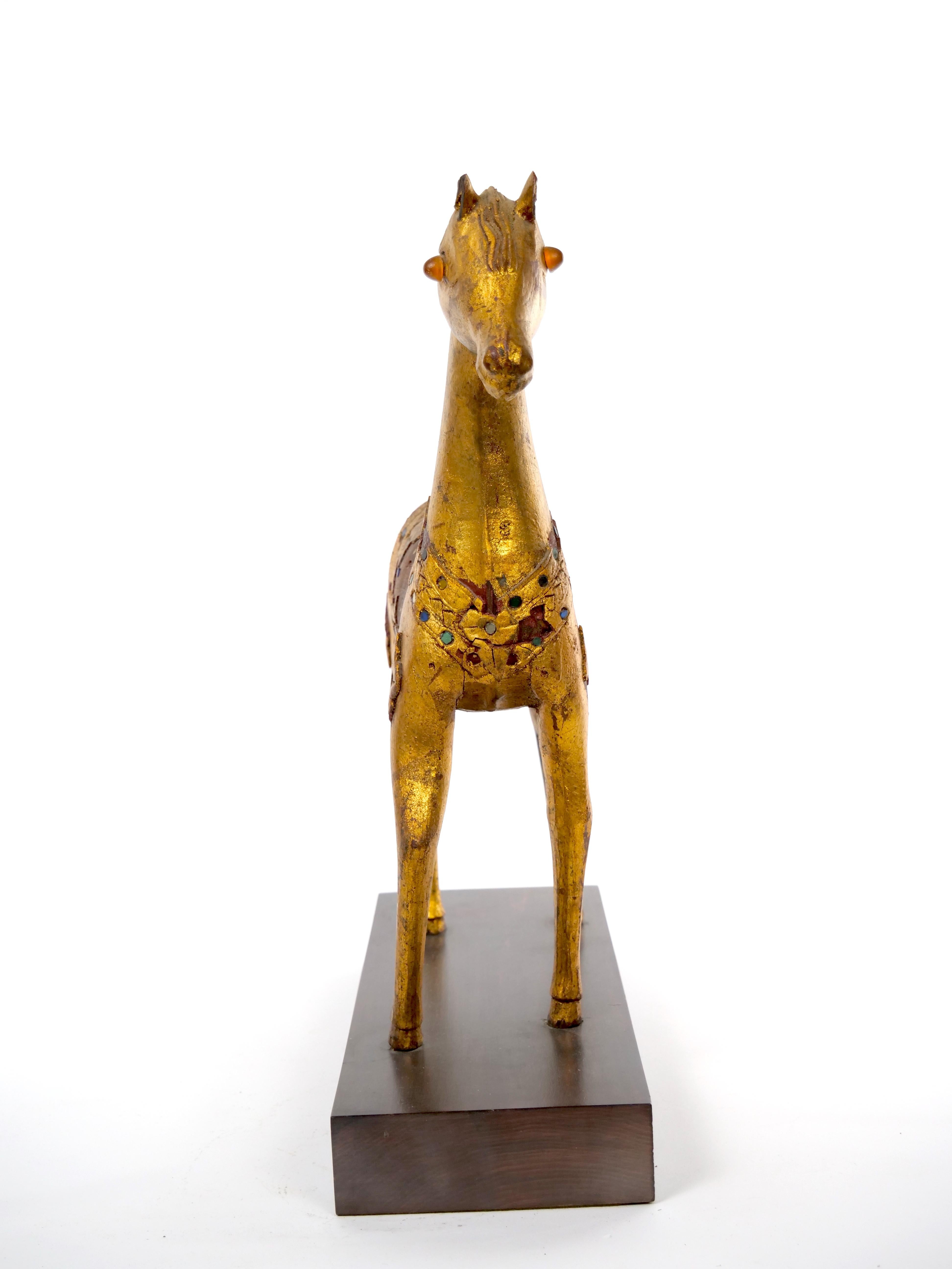 Large hand carved solid wood animal sculpture figurine with full gold leaf veneer. Intricate design and lovely patina. The decorative piece is in good condition with imperfections and minor losses to gilt consistent with age (see photos). It