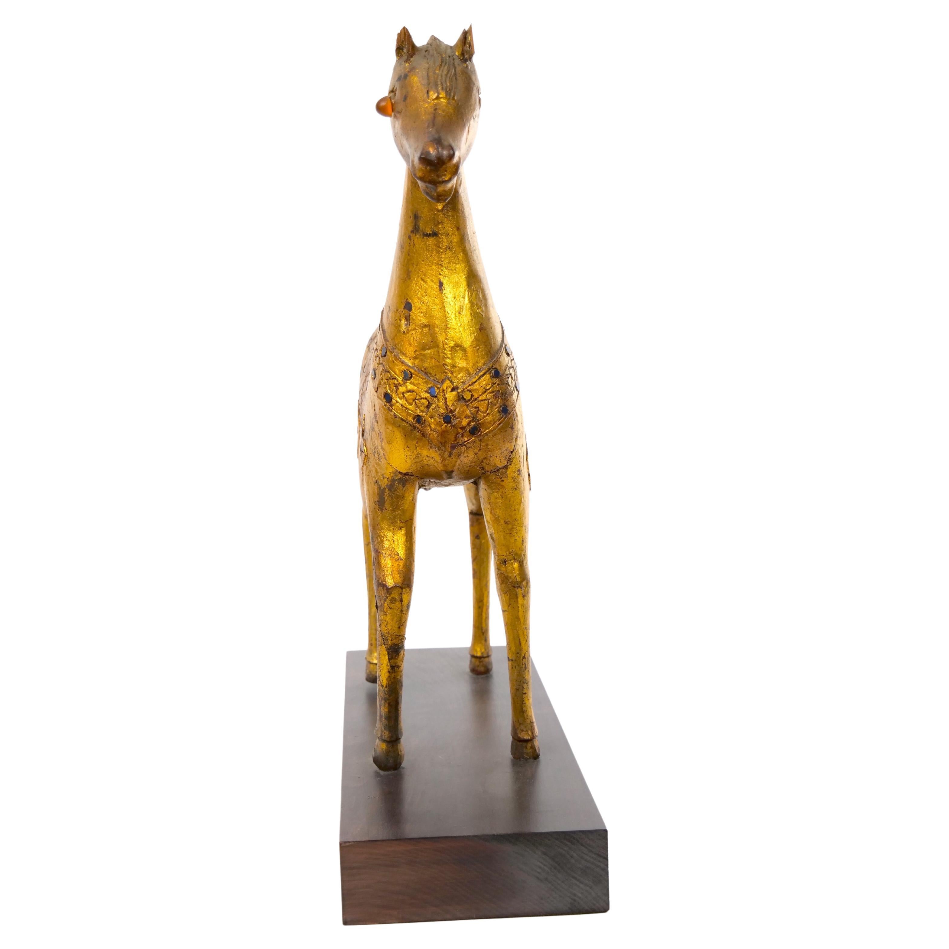 Large hand carved gilt gold wood animal sculpture horse figure with full gold leaf veneer. Intricate design and lovely patina. The decorative piece is in good condition with imperfections and minor losses to gilt consistent with age (see photos). It